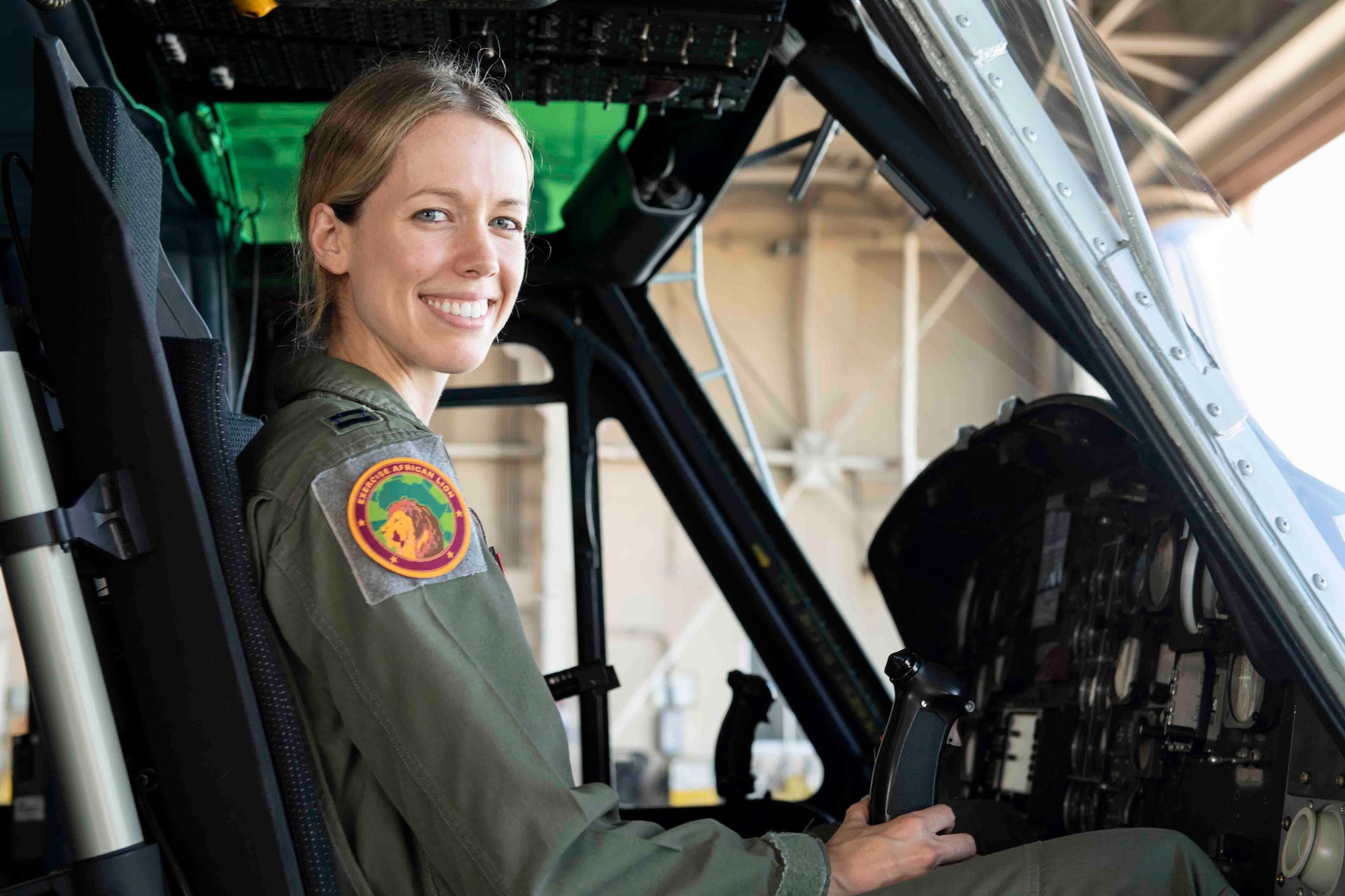 Capt. Jennie Seibert, 459th Airlift Squadron UH-1N Huey pilot and chief of training, sits in a UH-1N at Yokota Air Base, Aug. 4, 2021.
