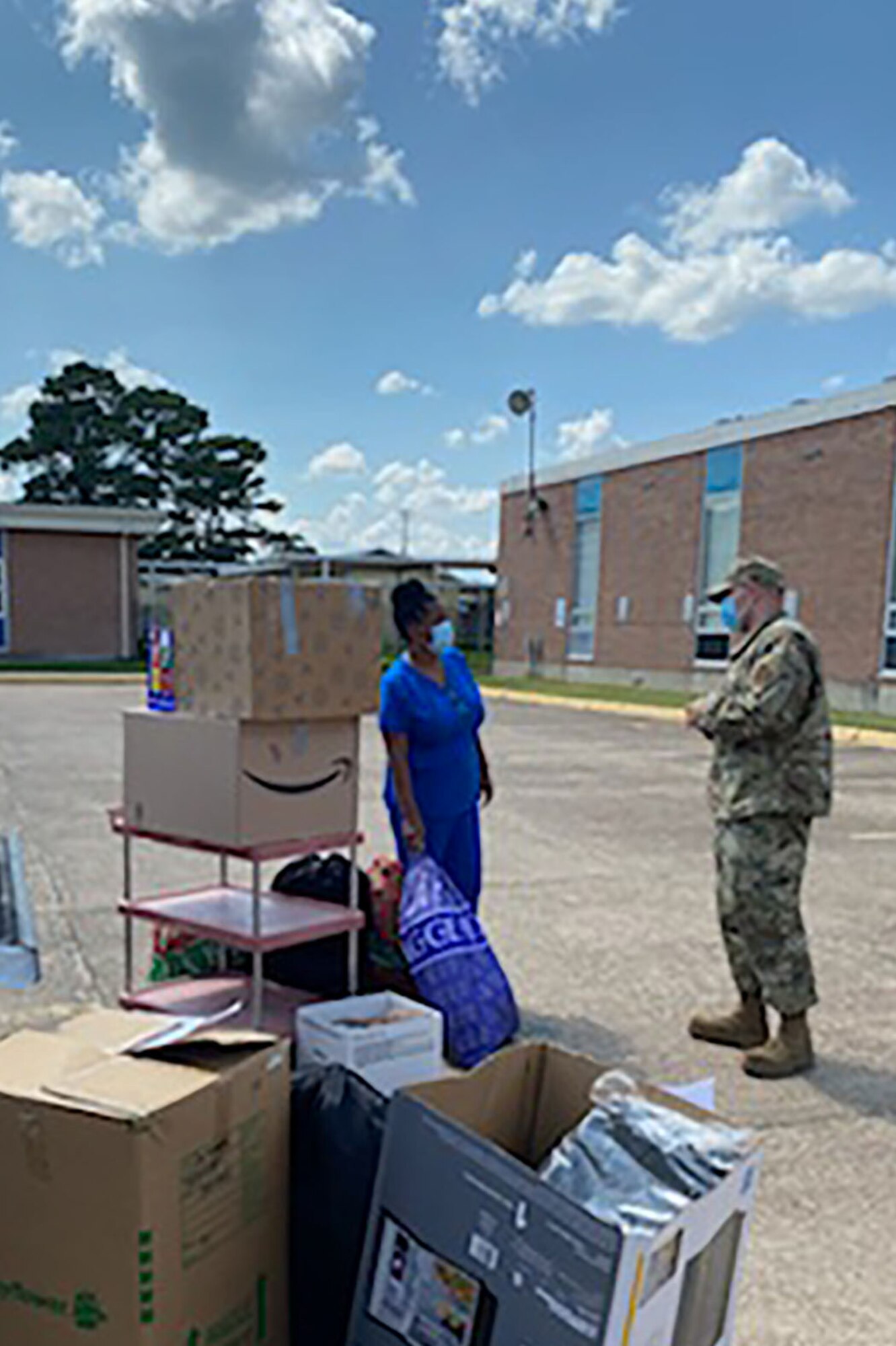 Photo of Airman surrounded by boxes.