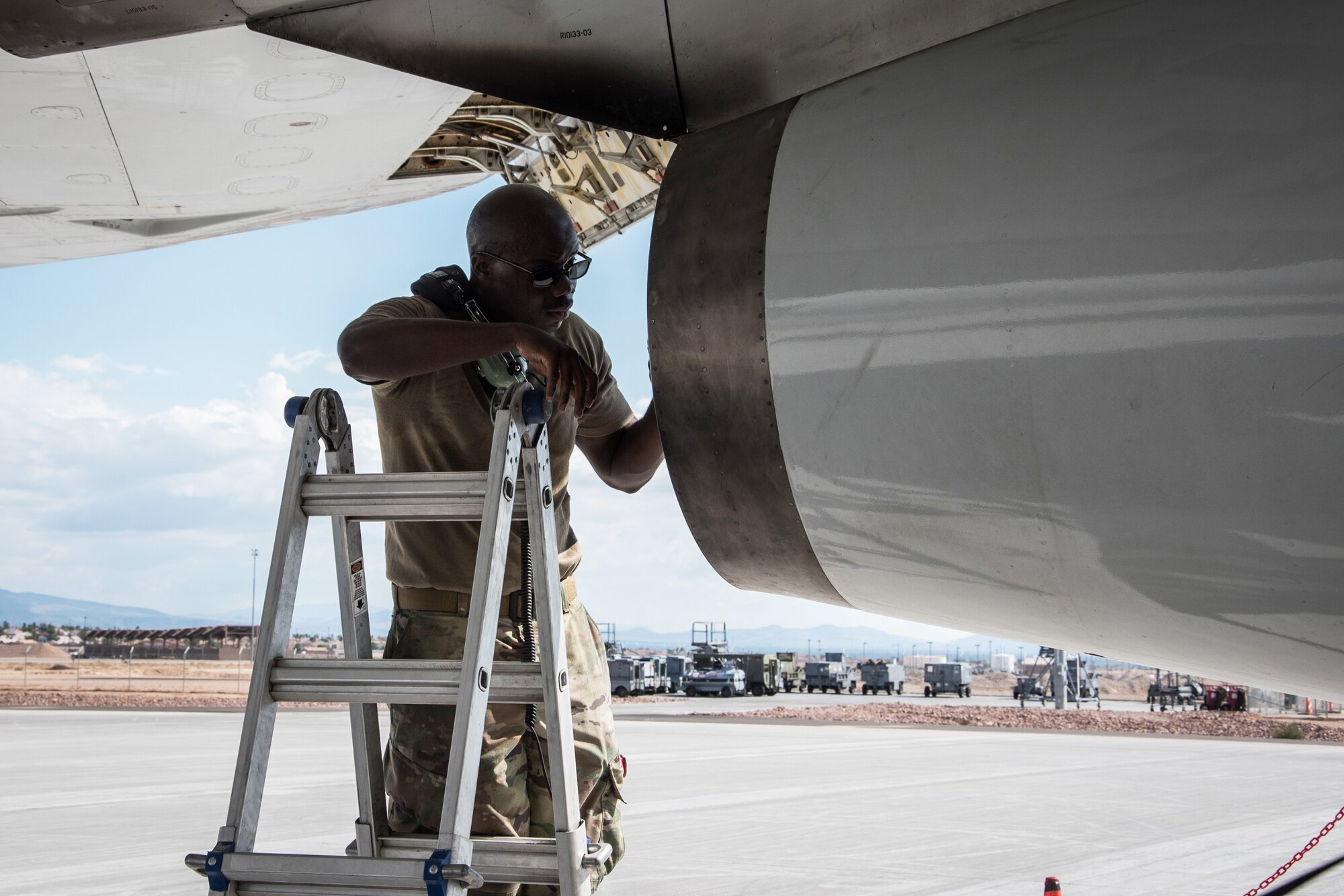 Maintainer inspecting the jet engine