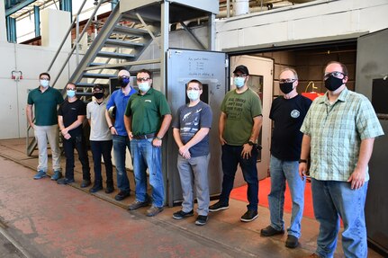 From Left to Right: Code 930 Computer Integrated Manufacturing Technician Sean Schuffert, Shop 31 Cold Spray Machinist Sterling Slaughter, Code 265 Mechanical Engineer Chester Acuna, Code 265 Mechanical Engineer Claude Brooks, Code 265 Submarine and Piping Mechanical Branch Head and NNSY Cold Spray Lead Dan Stanley, Shop 31 Cold Spray Machinist Jeff Brittingham, Shop 31 Cold Spray Machinist Tim Holland, Shop 31 Cold Spray Supervisor Jim Wiseman, and Code 930 Additive Repair Zone Manager Nick Allen.