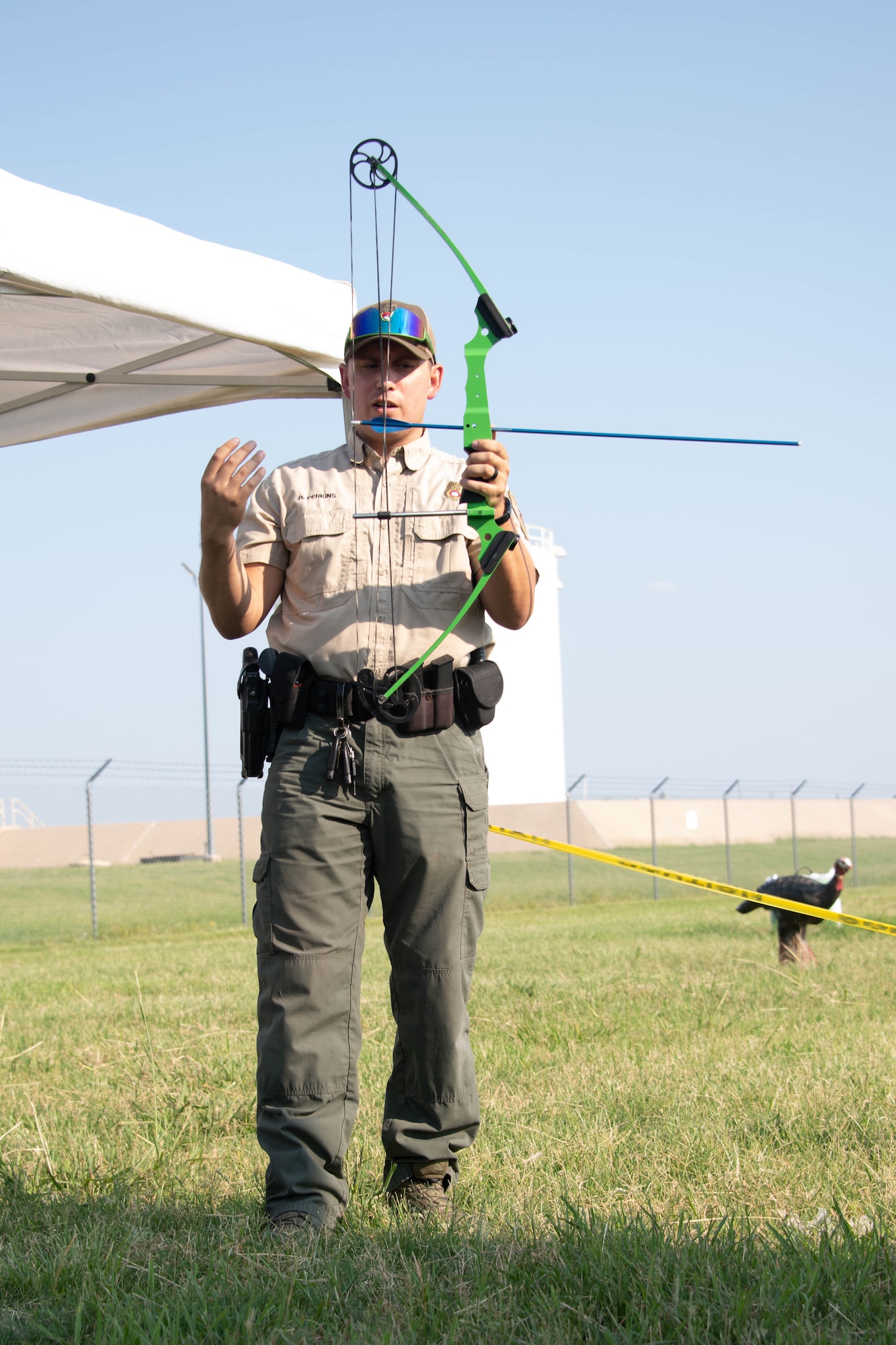 Daniel Perkins, Oklahoma Department of Wildlife Conservation (ODWC) state game warden, explains the basic parts of a bow and how they work on Altus Air Force Base, Oklahoma, July 30th, 2021. Perkins taught Airmen and family members how to use bow and arrows and educated them on the many programs offered by the ODWC. (U.S. Air Force Photo by Airman 1st Class Trenton Jancze)