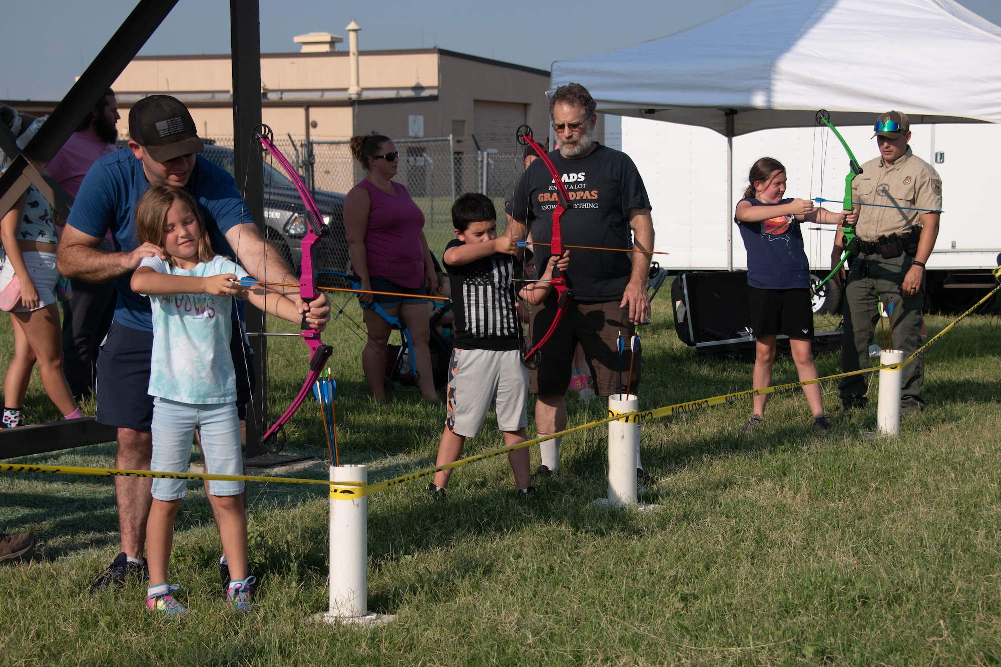 Airmen and family members fire arrows at hunting targets on Altus Air Force Base, Oklahoma, July 30th, 2021. At the event, participants learned about the different programs the outdoor recreation office has while also learning how to use bow and arrows. (U.S. Air Force Photo by Airman 1st Class Trenton Jancze)