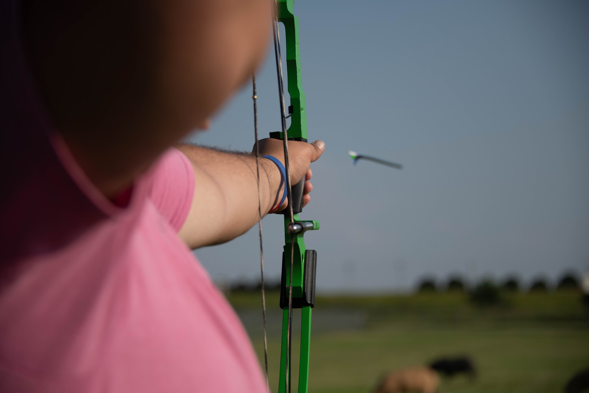 A participant shoots a bow at a target on Altus Air Force Base (AAFB), Oklahoma, July 30th, 2021. The AAFB outdoor recreation includes base parks, an archery range, paintball field, base pool, equipment rentals, and much more. (U.S. Air Force Photo by Airman 1st Class Trenton Jancze)