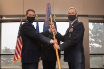 Commanders exchange guidon during change of command ceremony