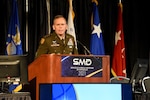 Army general speaks at podium.