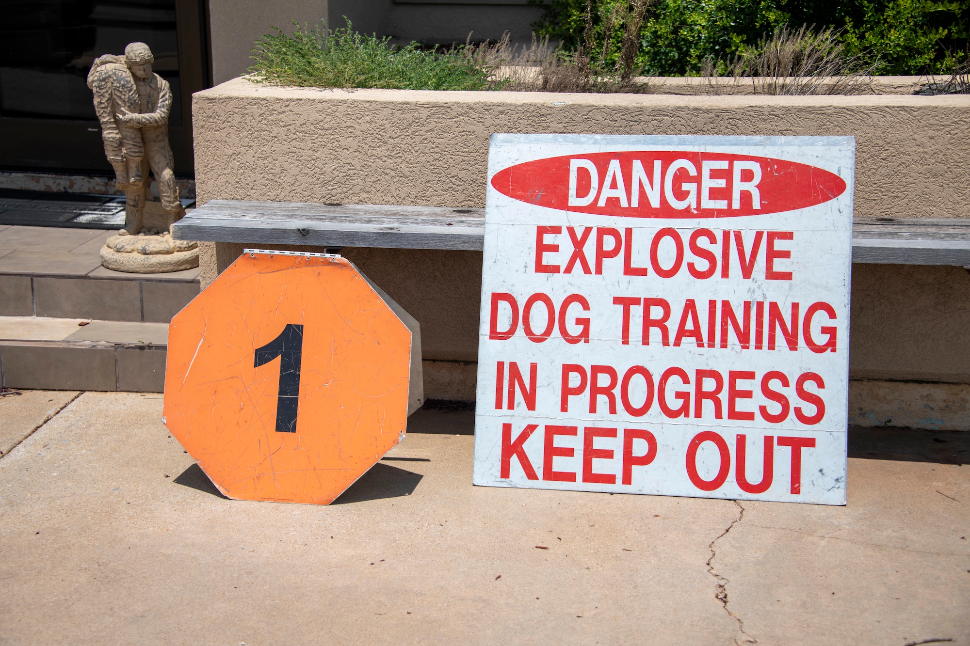 Signs are displayed to warn personnel about Military Working Dog (MWD) training using explosives at Altus Air Force Base, Oklahoma, July 28, 2021. The MWDs on base are trained on explosive or drug detection as well as the ability to take down a fleeing assailant. (U.S. Air Force photo by Staff Sgt. Cody Dowell)