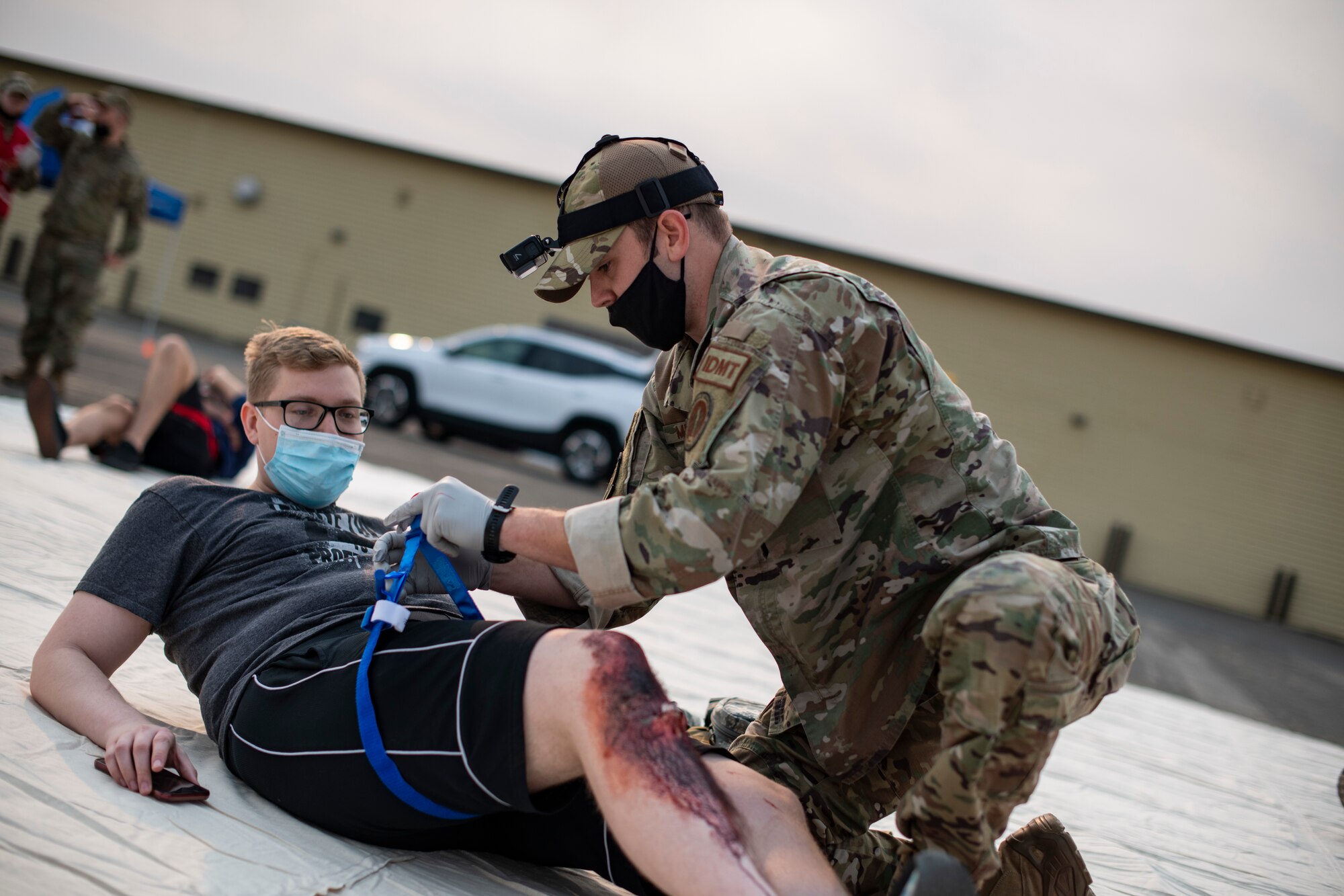 Staff Sgt. Casey Mulcahy, 9th Operational Medical Readiness Squadron operational medicine independent duty medical technician, tourniquets  a patient’s simulated leg wound during exercise Ready Eagle Aug. 6, 2021, at Beale Air Force Base, California.