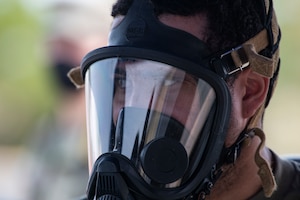 Senior Airman Cameron Harris, 9th Operational Medical Squadron bioenvironmental engineering journeyman, dawns protective gear while participating in exercise Ready Eagle, Aug. 6, at Beale Air Force Base, California.