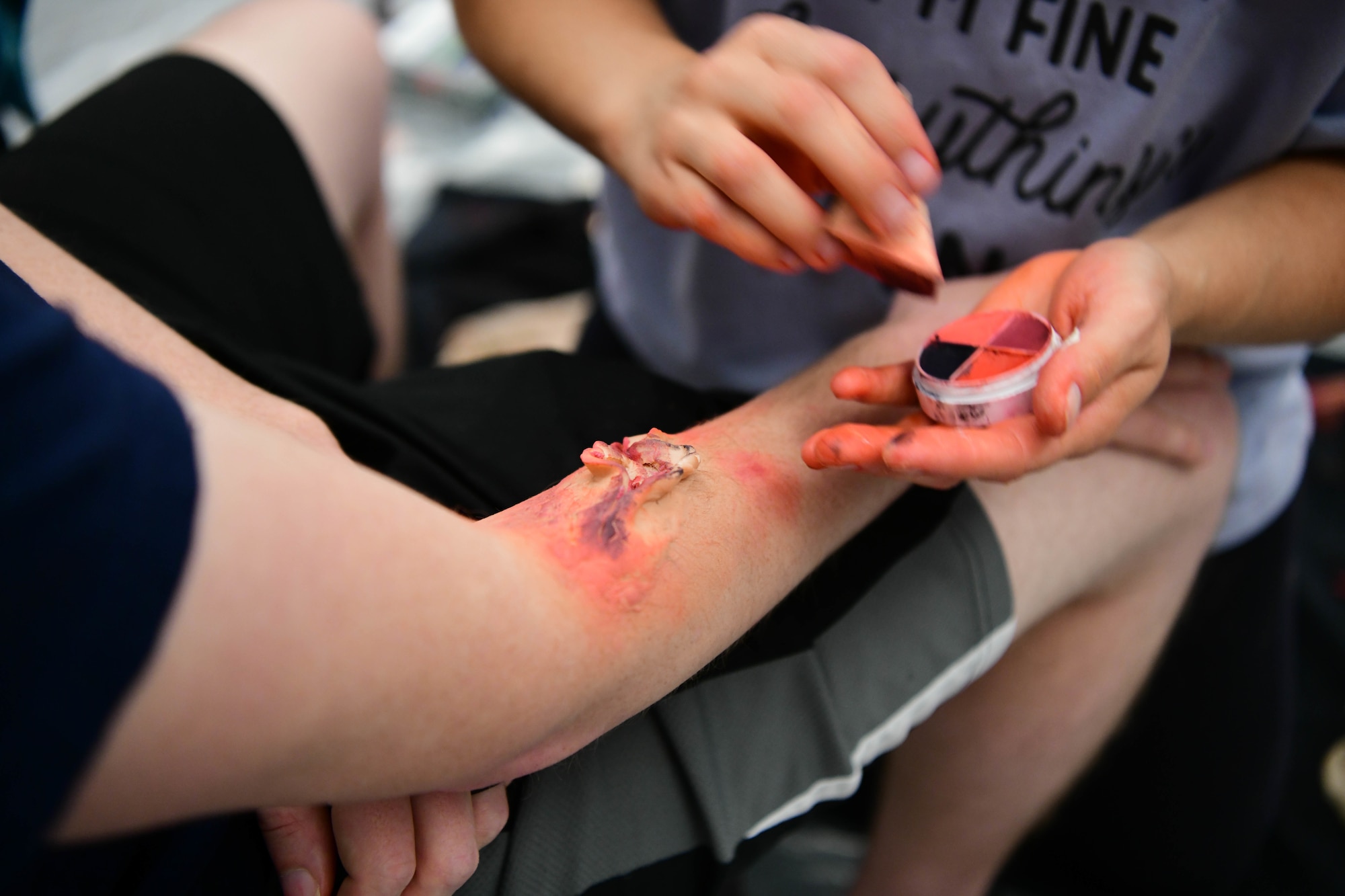 An Airman applies simulated wound makeup to another Airman’s arm during exercise Ready Eagle Aug. 6, 2021, at Beale Air Force Base, California.
