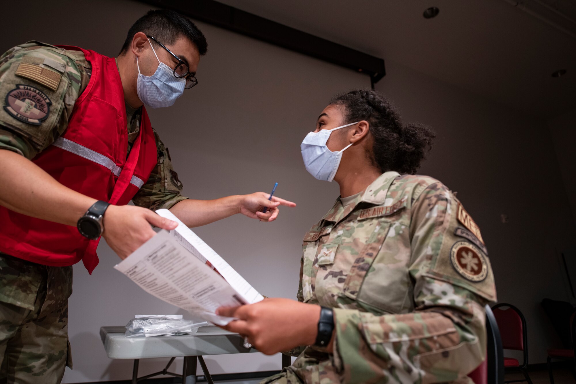 Capt. Mike Migita, 9th Healthcare Operations Squadron pediatrician, provides information about the anthrax vaccine to Airman 1st Class Erika Claridy, 9th Operational Medical Readiness Squadron aerospace medical technician, Aug. 5, 2021, at Beale Air Force Base, California.