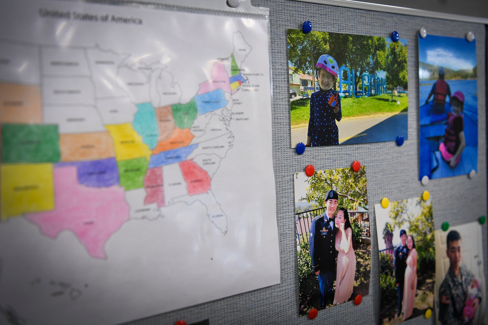 Family photos and a map of states’ visited stay pinned to the desk of Airman 1st Class Ling Yu, 66th Comptroller Squadron financial accounting technician, at Hanscom Air Force Base, Mass., Aug. 10. Yu came to the U.S. in 2013 while her husband served in the Army before enlisting herself in the Air Force in 2020. (U.S. Air Force photo by Lauren Russell)