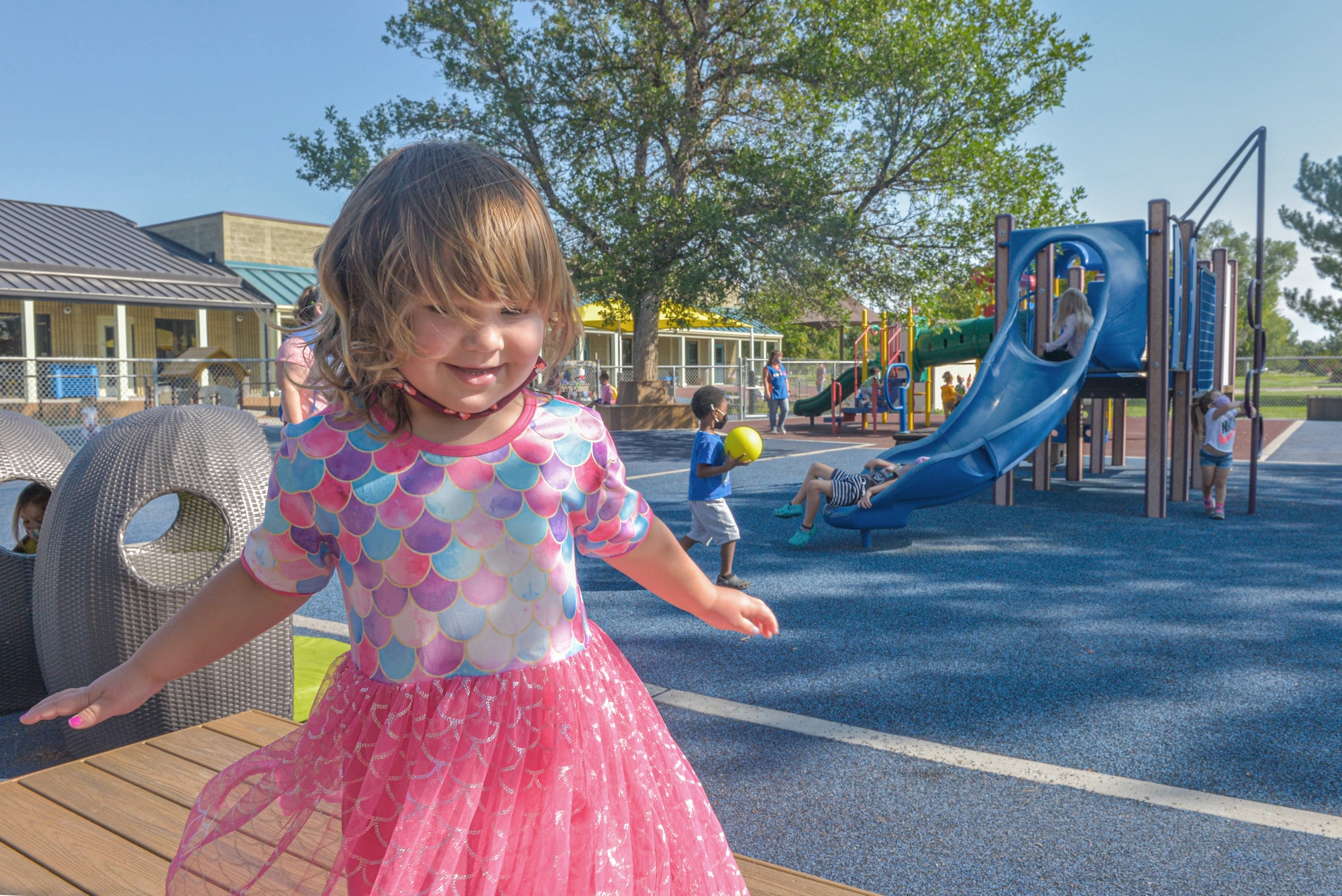 A child twirls for the camera during recess on Mountain Home Air Force Base, Idaho.