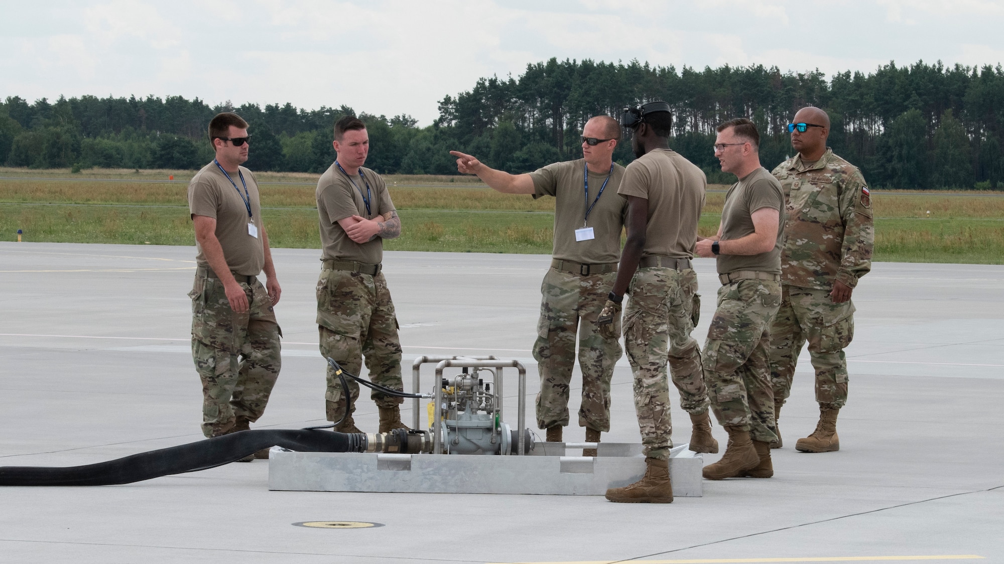 U.S. Air Force Airmen from the 480th Expeditionary Fighter Squadron and the 126th Air Refueling Wing, Scott Air Force Base, Ill., gather around the Versatile Integrating Partner Equipment Refueling Kit, or VIPER Kit, at Powidz Air Base, Poland, Aug. 10, 2021. The Airmen discussed VIPER Kit set up procedures when servicing a U.S. Air Force KC-135 Stratotanker aerial refueling aircraft. (U.S. Air Force photo by Tech. Sgt. Anthony Plyler)