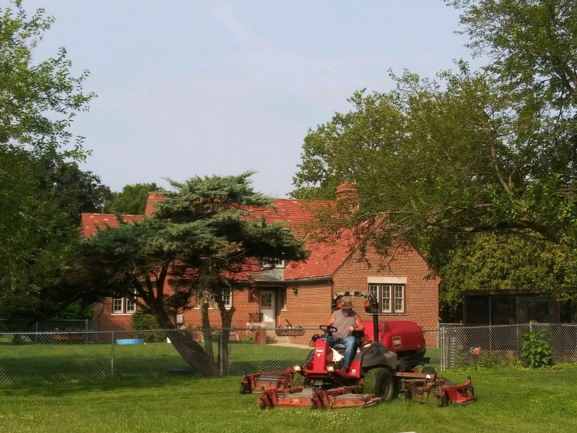 88th Civil Engineer Squadron personnel cuts grass in a Brick Quarters common area.