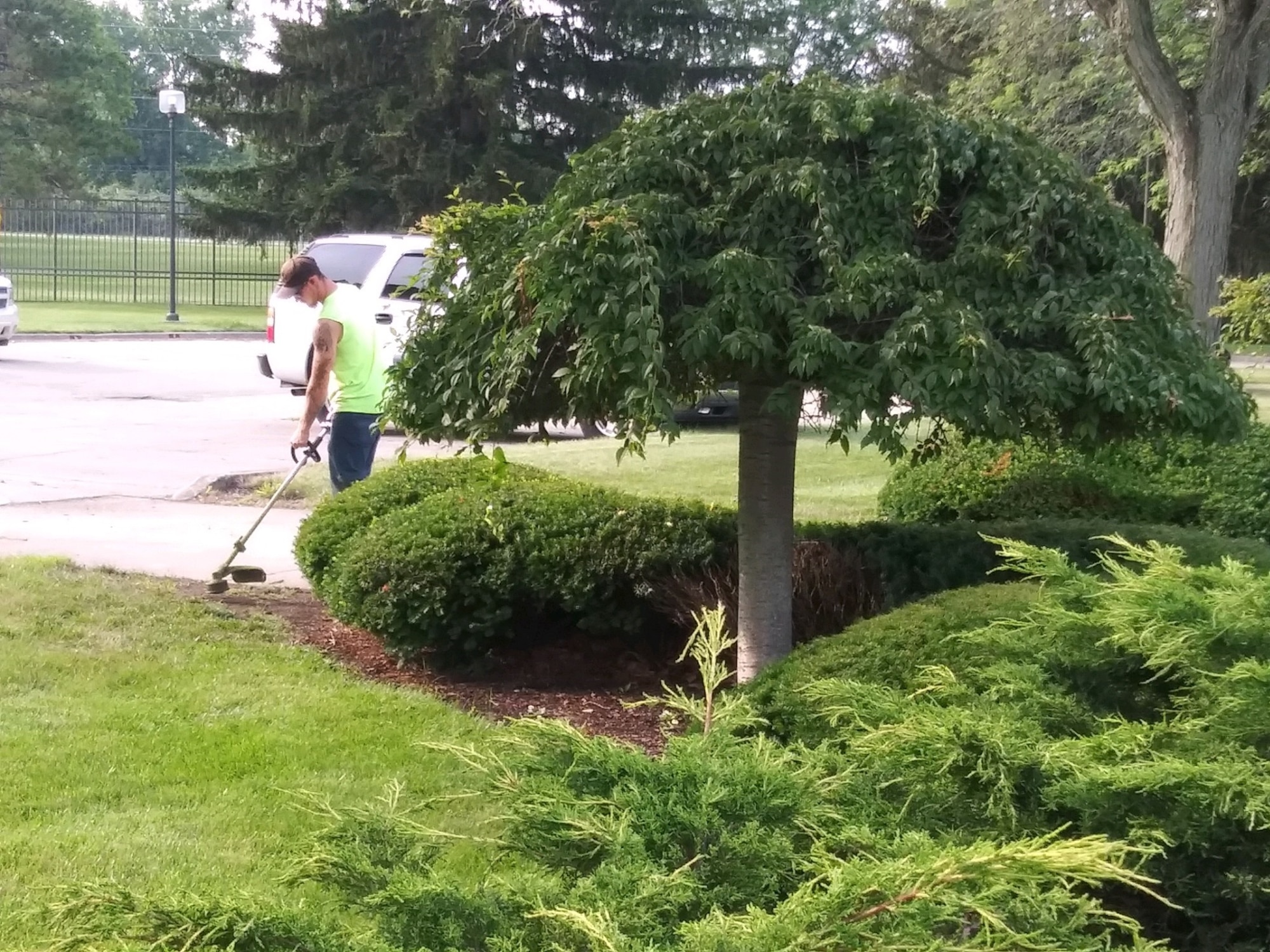 88th Civil Engineer Squadron equipment operator, trims  weeds and hedges at Air Force Materiel Command headquarters.