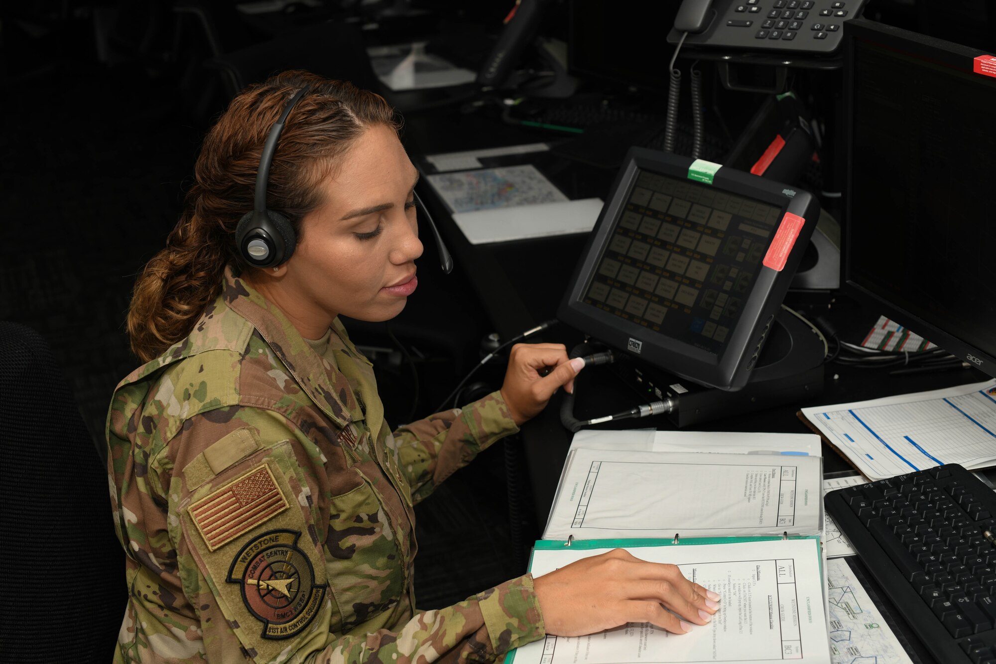 U.S. Air Force Airman 1st Class Yara Martinez looks over a binder.