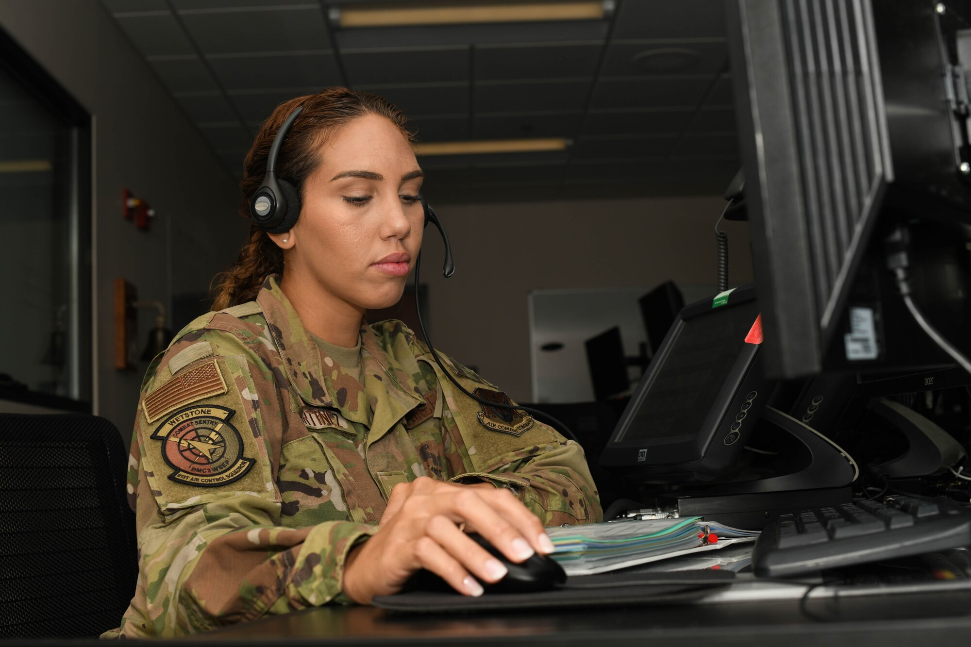 U.S. Air Force Airman 1st Class Yara Martinez looks over a binder.