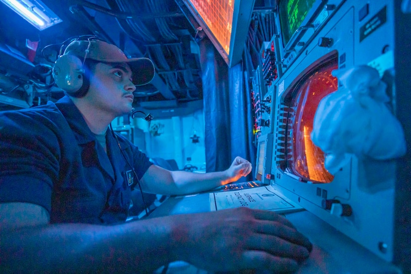 A sailor monitors a radar screen.