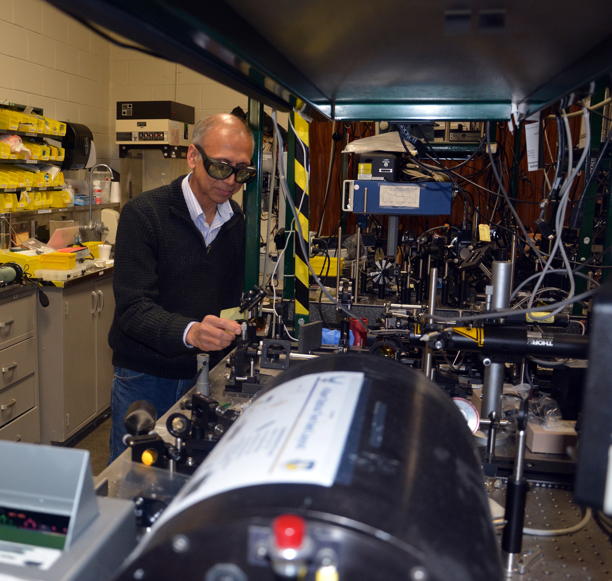 An electro-optics survivability team of Air Force Research Laboratory personnel earned a 2021 U.S.- UK Science & Technology Stocktake Team Achievement Award for their work and experimentation with lasers. Seen here in a laser lab, team member, Dr. Shekhar Guha, a senior scientist in AFRL’s Materials and Manufacturing Directorate, adjusts an optic behind a carbon dioxide laser. (U.S. Air Force photo/Donna Lindner)