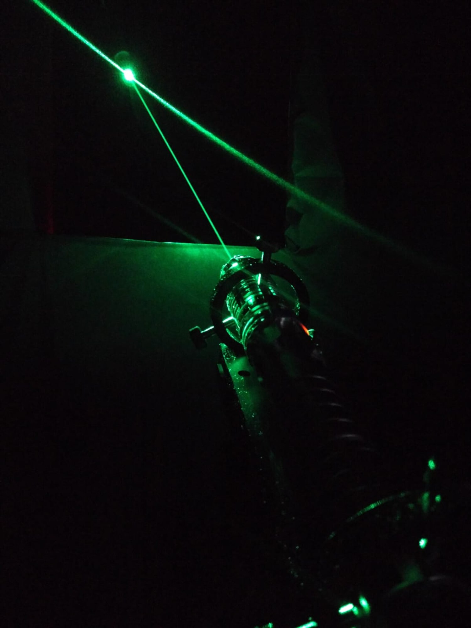 A handheld laser reflects off of a cable car during a NATO trial in which the U.S. and UK participated. The electro-optic survivability team experiments with lasers, which informs lasers’ potential use as directed energy weapons for U.S. and UK defense. (Photo by Chris Westgate, Dstl)
