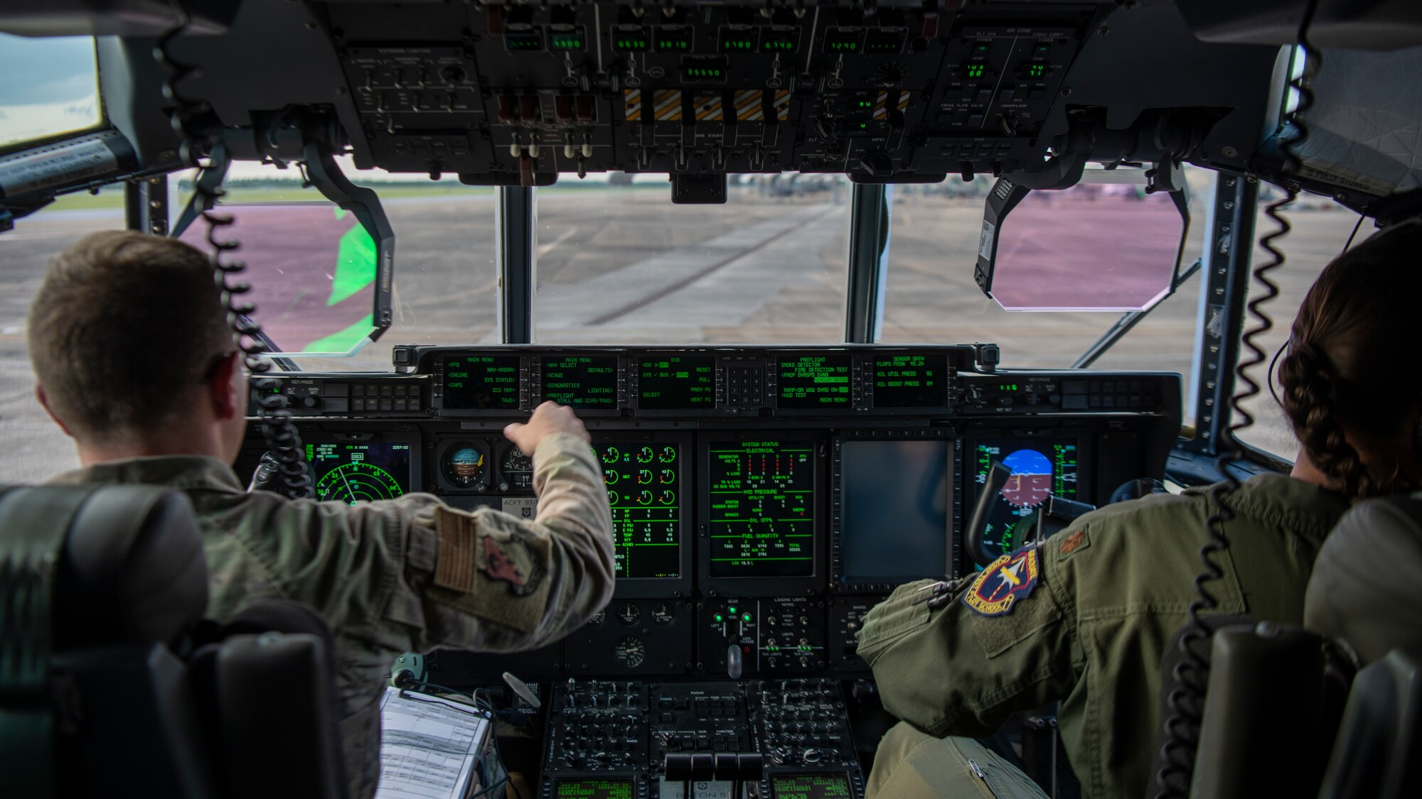 U.S. Air Force Maj. Jonathan Forsyth, left, a 492nd Special Operations Training Group Detachment 2 instructor pilot, and U.S. Air Force Maj. Catherine Olszewski, a 417th Flight Test Squadron pilot, perform pre-flight inspections on a modified EC-130J Commando Solo at Eglin Air Force Base, Florida, Aug. 5, 2021.