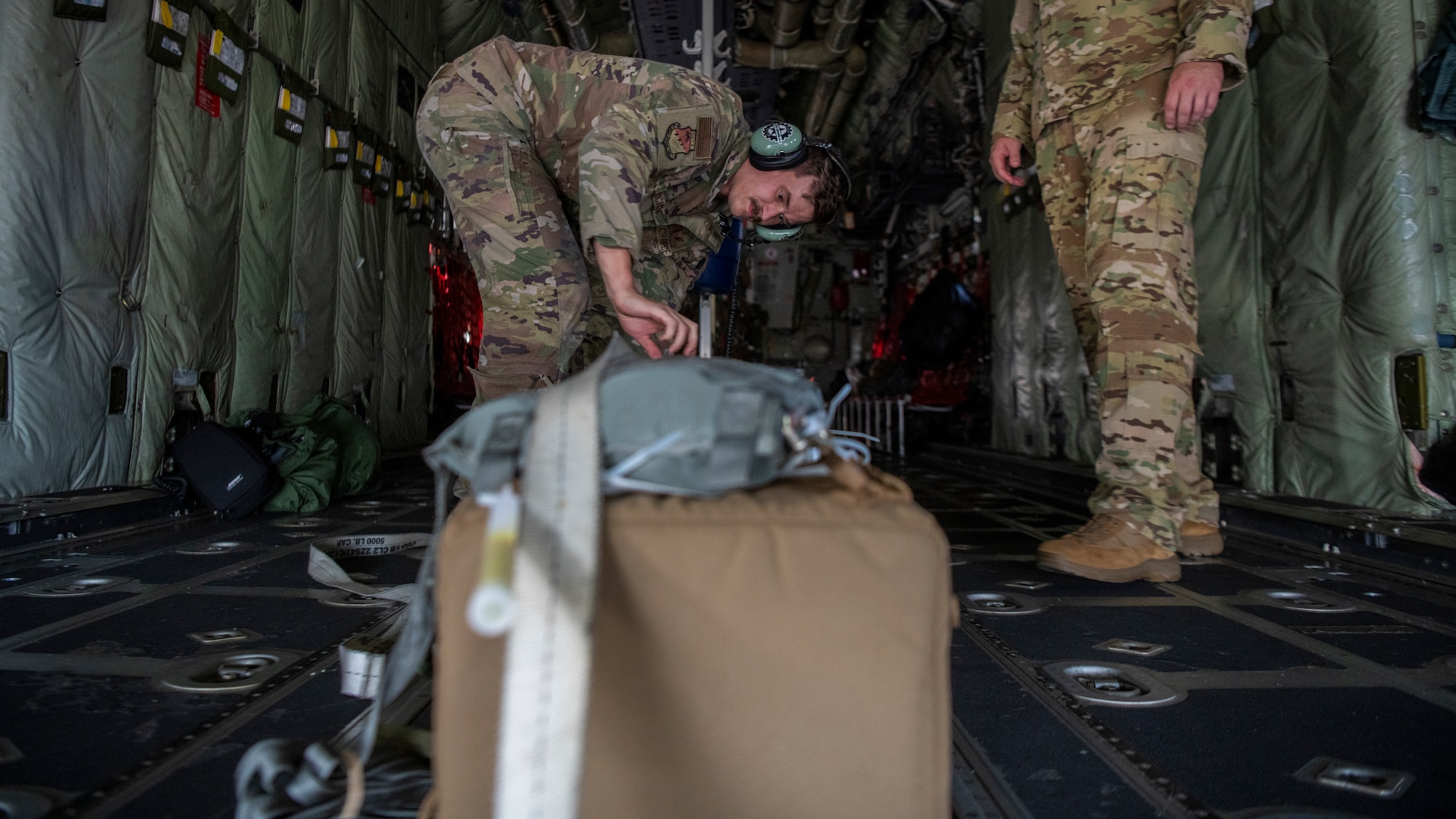 U.S. Air Force Tech. Sgt. John Richman, a 492nd Special Operations Training Group Detachment 2 loadmaster, straps a thermal blood transport box in a modified EC-130J Commando Solo during Operation Blood Rain at Eglin Air Force Base, Florida, Aug. 5, 2021.