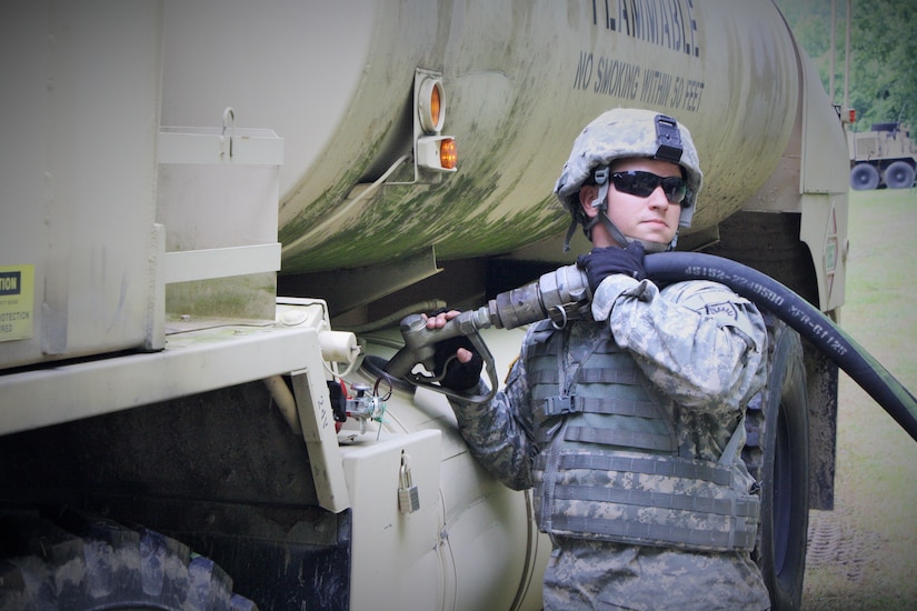 pc. Chase Byrum, petroleum supply specialist (92F), with Distribution Company, 149th Brigade Support Battalion fuels an M978A4 HEMTT Tanker at Harold L. Disney training area, June 5, 2016 in preparation for a Logistics Package (LOGPAC) convoy.