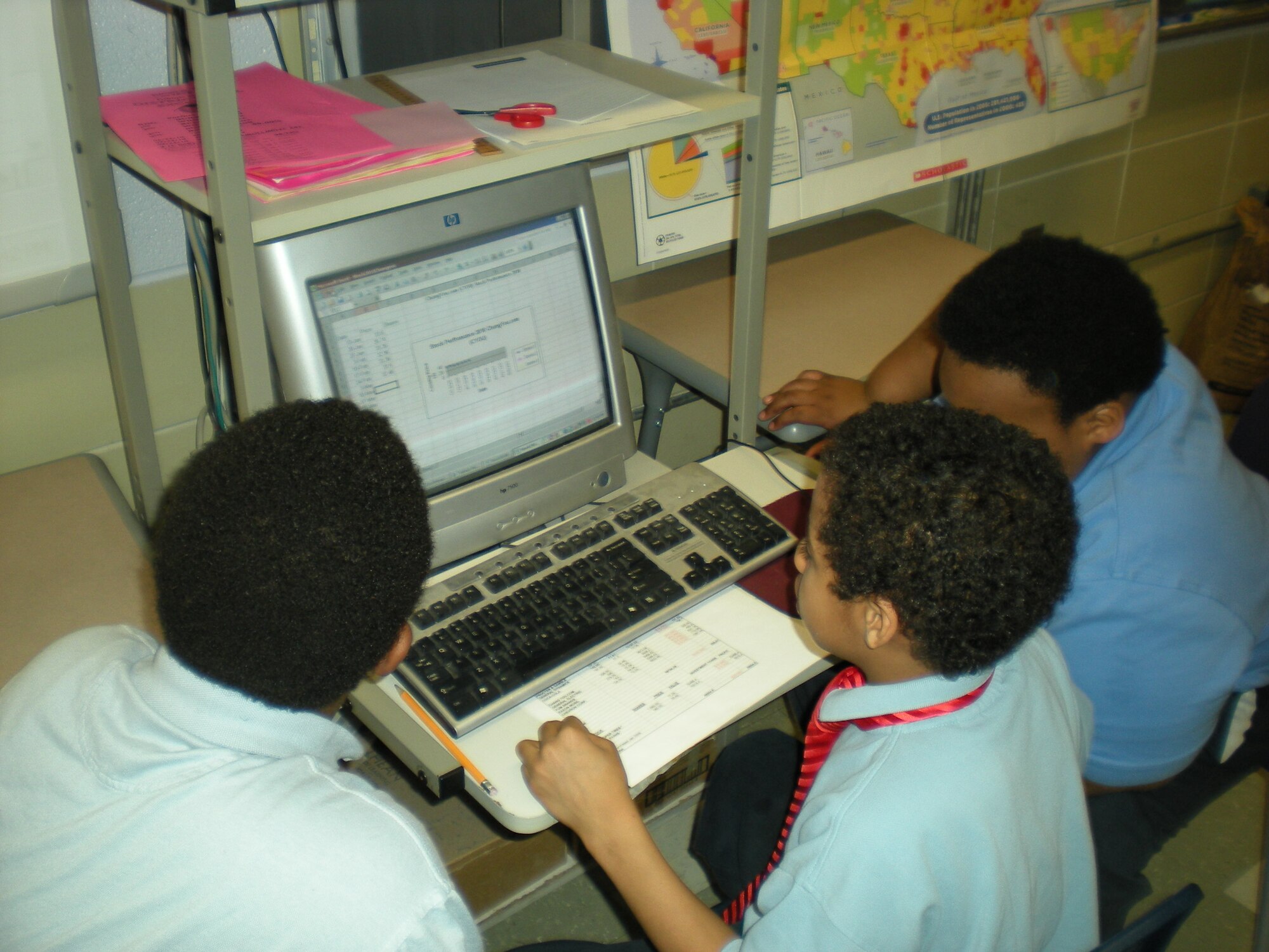 Gregory Powell’s fourth-grade students work on a stock market activity. Powell coined a stock market activity called “Our Stock is Rising” that helps teach young students the benefits of financial investing. (Courtesy photo)