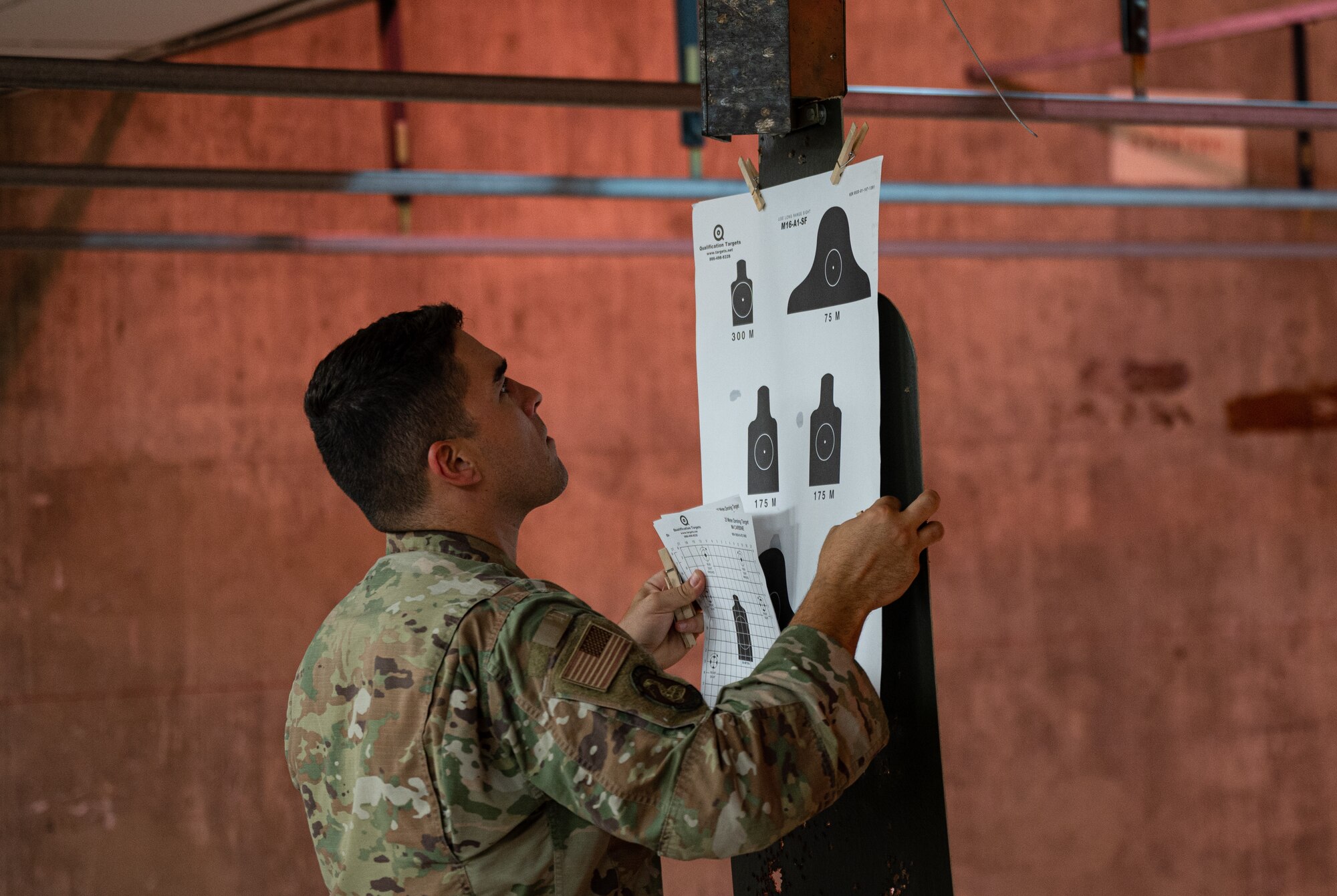 U.S. Air Force Senior Airman Ramon Rosa Aponte, 56th Security Forces Squadron defender, hangs targets during a weapons qualification course Aug. 3, 2021, at Luke Air Force Base, Arizona.