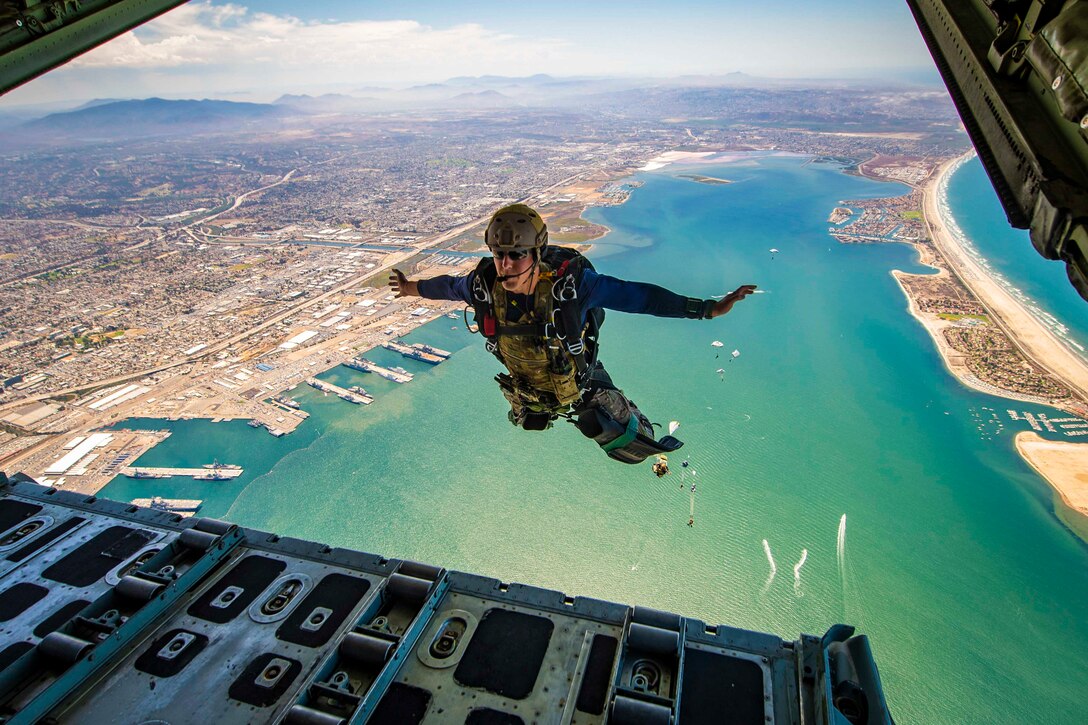 A sailor jumps out of an aircraft.