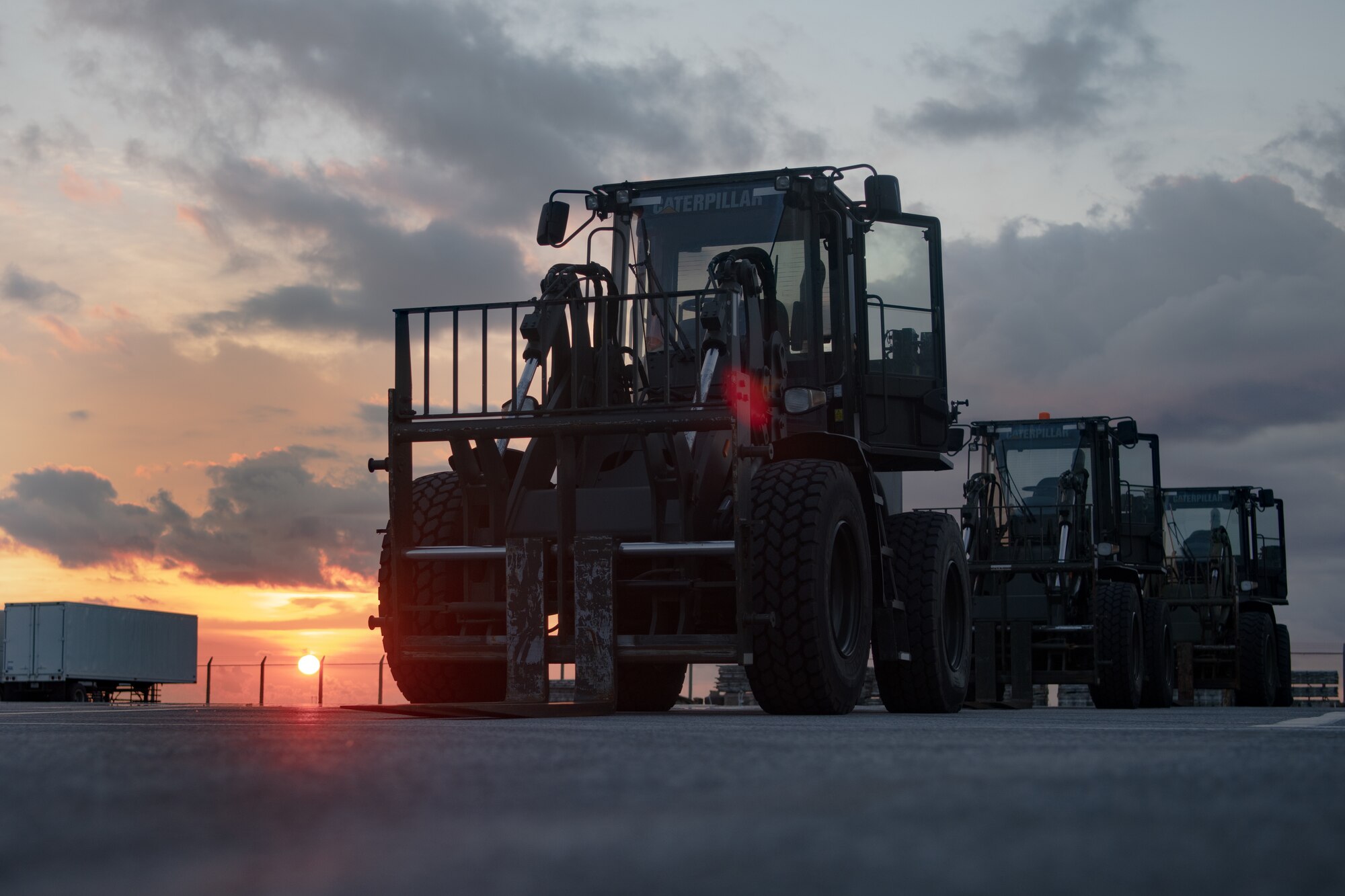 Caterpillar 10K All Terrain Forklifts assigned to the 18th Logistics Readiness Squadron ground transportation section, are parked in preparation for a mail shipment at Kadena Air Base, Japan, July 31, 2021. Airmen from the ground transportation section used forklifts to transport 39 pallets of mail to be broken down by Airmen and Marines. The forklifts have a carrying capacity of 10-thousand pounds and can reach a height of 96-inches when fully loaded.  (U.S. Air Force photo by Airman 1st Class Stephen Pulter)