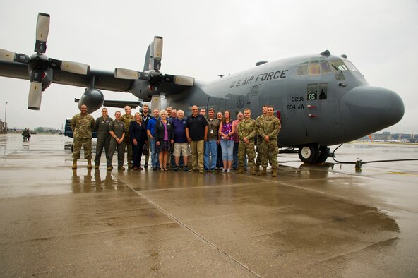 Employers pose next to a 934th Airlift Wing C-130H during Employer's Day at at Minneapolis-St. Paul Air Reserve Station, Aug. 30, 2021. (Air Force photo by Chris Farley)