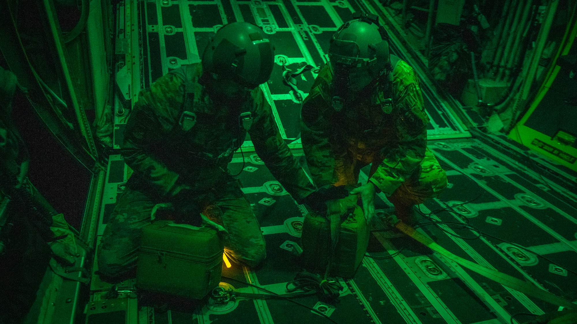 U.S. Air Force Tech. Sgt. John Richman, a 492nd Special Operations Training Group Detachment 2 loadmaster, left, and U.S. Air Force Lt. Col. William Smith, right, the Air Force Special Operations Command integration and operability chief, grab thermal blood transport boxes during Operation Blood Rain near Eglin Range, Florida, Aug. 5, 2021.