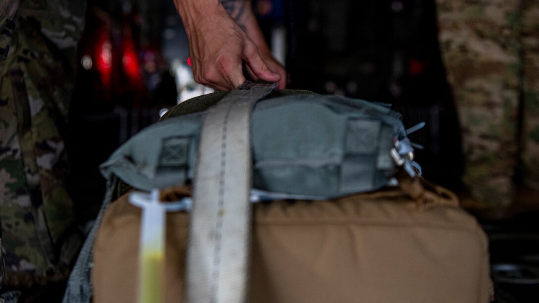 U.S. Air Force Tech. Sgt. John Richman, a 492nd Special Operations Training Group Detachment 2 loadmaster, straps a thermal blood transport box in a modified EC-130J Commando Solo during Operation Blood Rain at Eglin Air Force Base, Florida, Aug. 5, 2021.