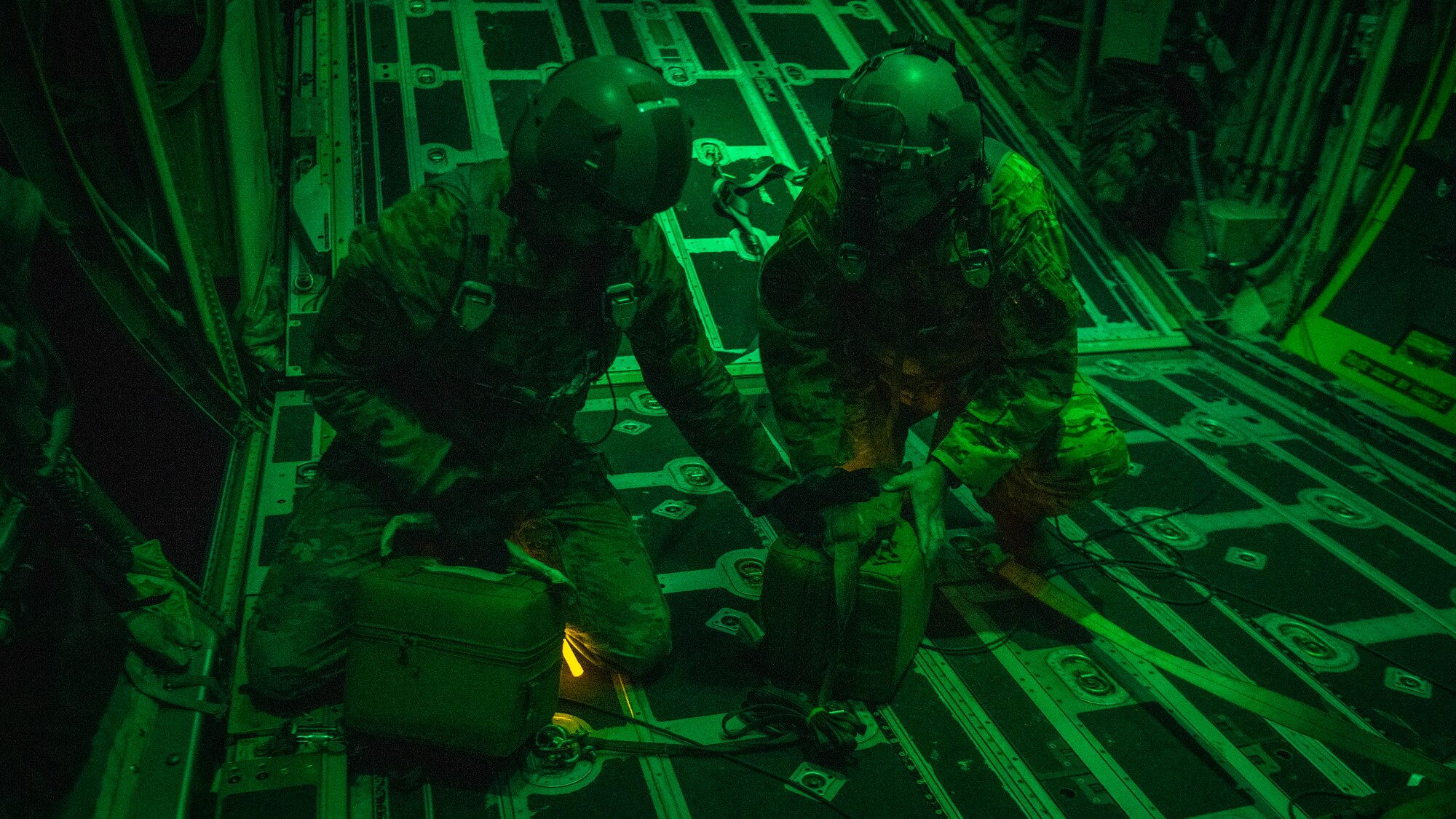 U.S. Air Force Tech. Sgt. John Richman, a 492nd Special Operations Training Group Detachment 2 loadmaster, left, and U.S. Air Force Lt. Col. William Smith, right, the Air Force Special Operations Command integration and operability chief, grab thermal blood transport boxes during Operation Blood Rain near Eglin Range, Florida, Aug. 5, 2021.