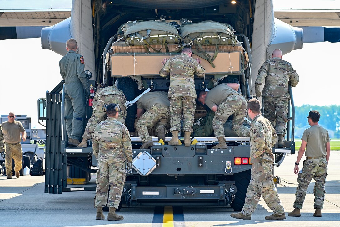 The 294th Quartermaster Company, 36th Sustainment Brigade, Texas National Guard, helps the 182nd Wing, Illinois Air National Guard, load a C-130 Hercules aircraft with Humvees and a pallet of sustainment supplies during Northern Strike 21-2 at Selfridge Air National Guard Base, Michigan, Aug. 4, 2021.