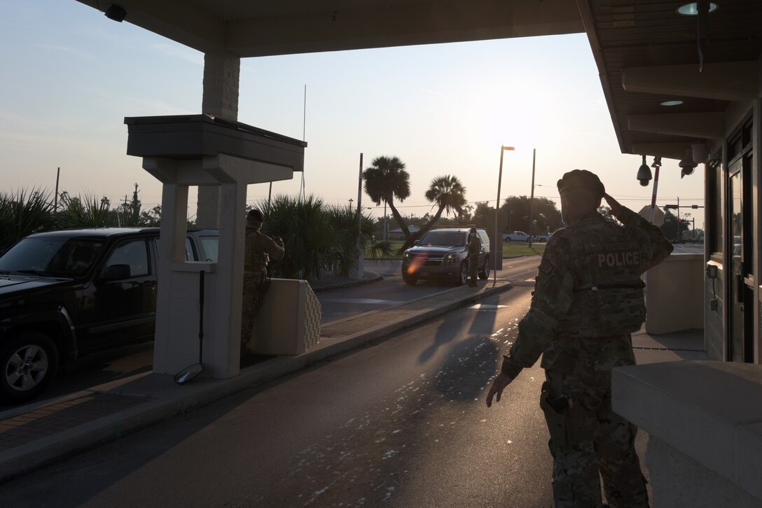 Members of the 325th Security Forces Squadron verify base access credentials