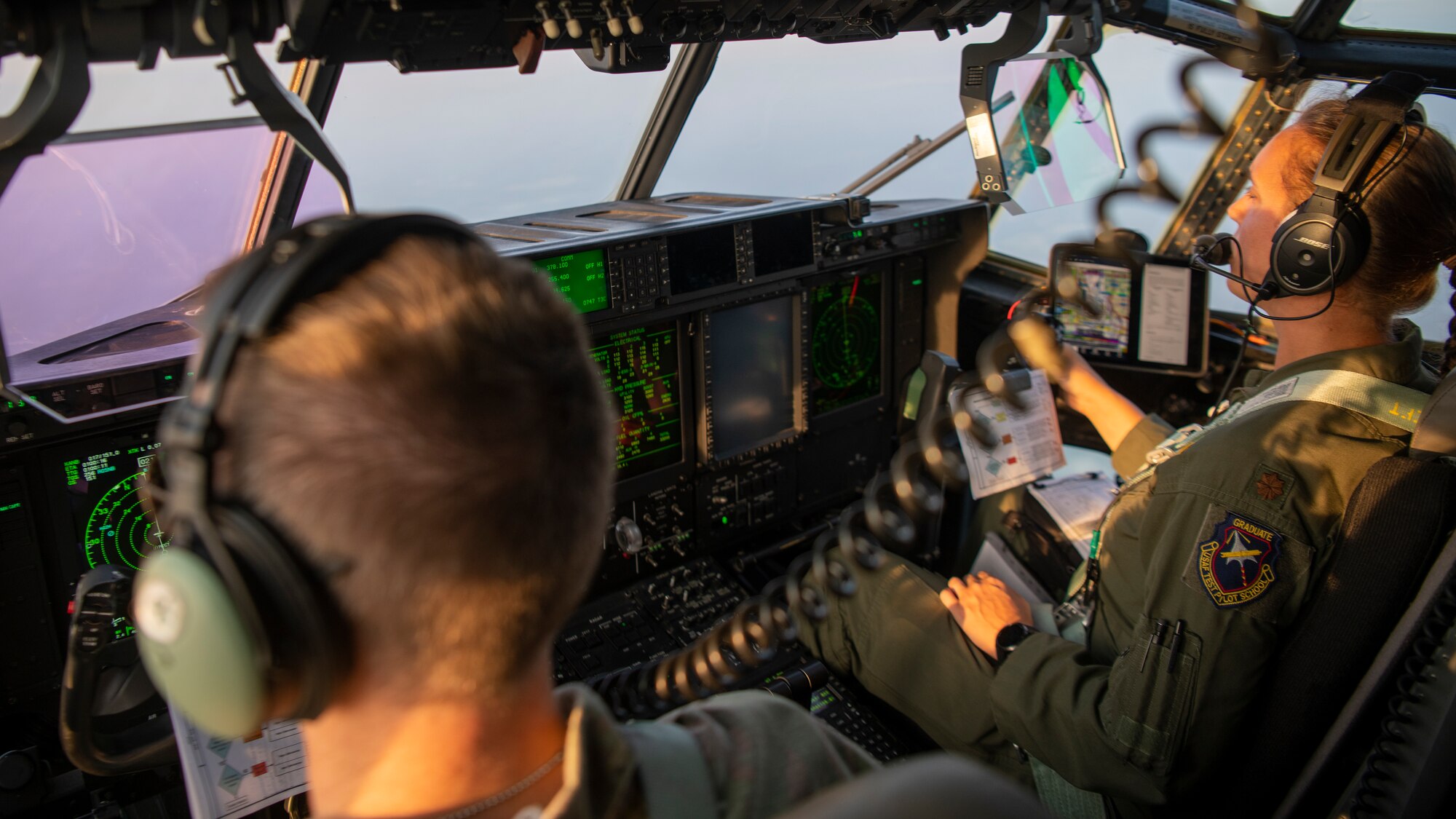 U.S. Air Force Maj. Jonathan Forsyth, left, a 492nd Special Operations Training Group Detachment 2 instructor pilot, and U.S. Air Force Maj. Catherine Olszewski, a 417th Flight Test Squadron pilot, fly an EC-130J Commando Solo during Operation Blood Rain near Eglin Range, Florida, Aug. 5, 2021.