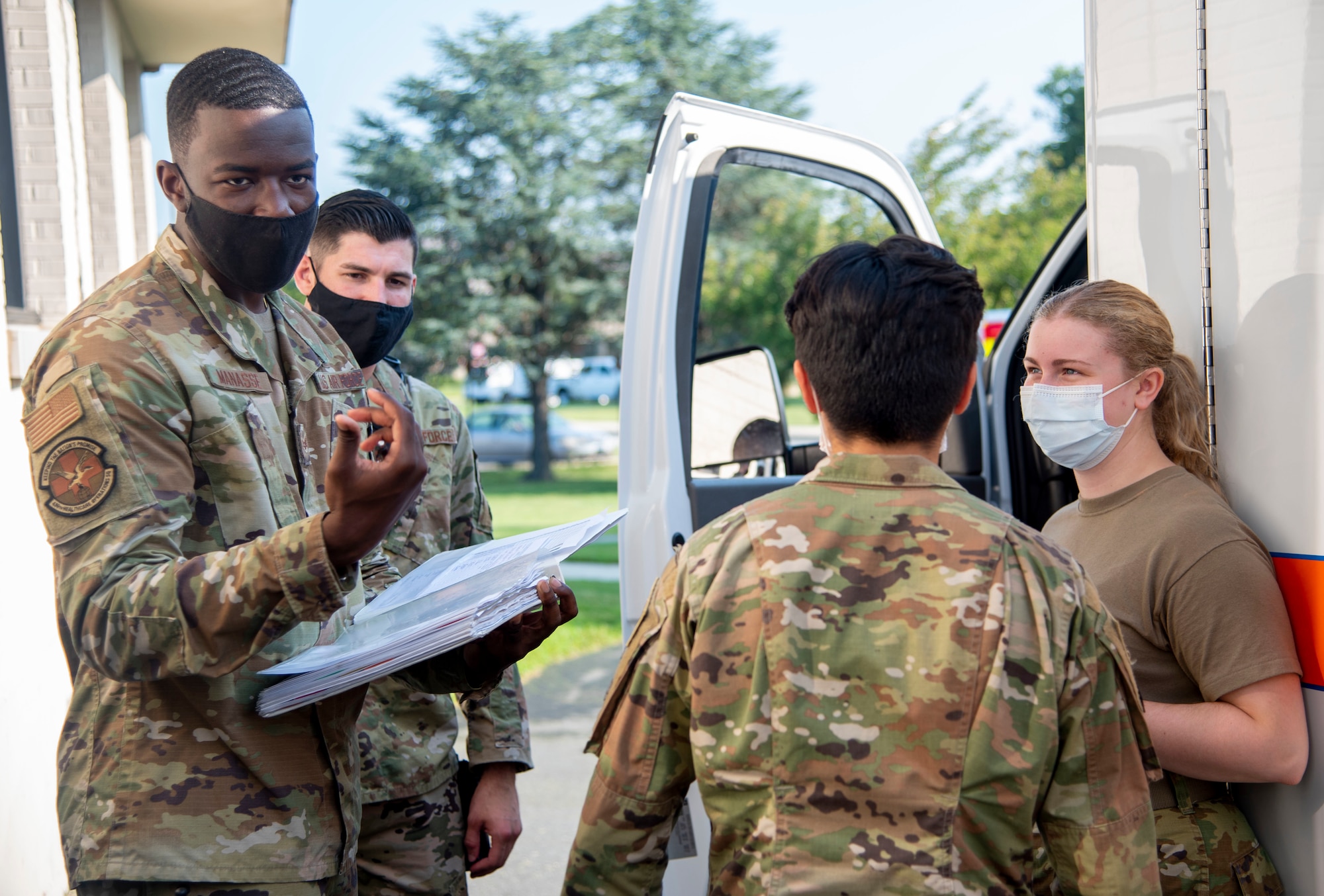 Senior Airman Floydler Manasse, left, 436th Health Care Operations Squadron emergency medical technician, discusses protocols for ambulance operation during ambulance response team augmentee training at Dover Air Force Base, Delaware, Aug. 11, 2021. The 436th Medical Group is training clinical medics to become augmentees during emergency calls, allowing core medics to focus on patients, improving overall patient safety. (U.S. Air Force photo by Tech. Sgt. Nicole Leidholm)