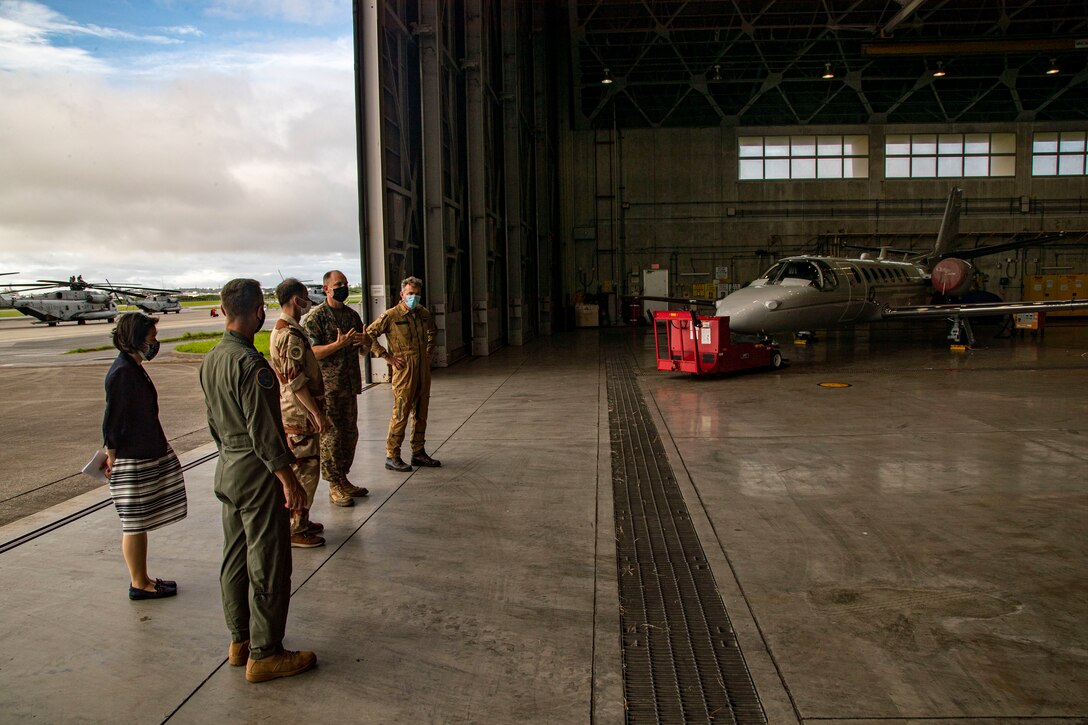 U.S. military officials stationed on Okinawa, foreign military and civilian personnel with United Nations Command Rear (UNC-R), and Government of Japan (GOJ) representatives participate in an air station tour on Marine Corps Air Station (MCAS) Futenma, Okinawa, Japan, Aug. 4, 2021. UNC-R and GOJ visited MCAS Futenma to provide an opportunity for the UNC-R to meet the MCAS Futenma team and discuss local considerations that may impact future planning in establishing a possible UNC-R footprint. (U.S. Marine Corps photo by Lance Cpl. Jonathan A. Beauchamp)
