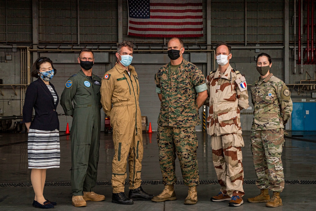 U.S. military officials stationed on Okinawa, foreign military and civilian personnel with United Nations Command Rear (UNC-R), and Government of Japan (GOJ) representatives participate in an air station tour on Marine Corps Air Station (MCAS) Futenma, Okinawa, Japan, Aug. 4, 2021. UNC-R and GOJ visited MCAS Futenma to provide an opportunity for the UNC-R to meet the MCAS Futenma team and discuss local considerations that may impact future planning in establishing a possible UNC-R footprint. (U.S. Marine Corps photo by Lance Cpl. Jonathan A. Beauchamp)
