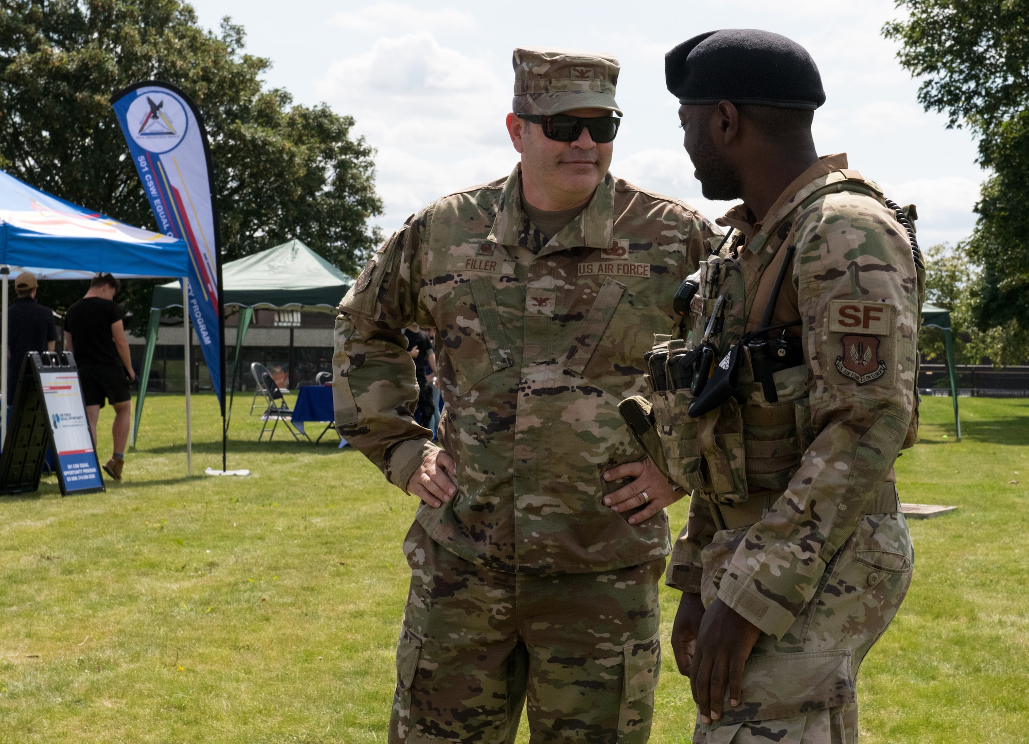U.S. Air Force Col. Brian Filler, 501st Combat Support Wing commander, chats with Staff Sgt. David Striggles, 423rd Security Forces Squadron patrolman, at the “End of Lockdown” block party at Royal Air Force Alconbury Alconbury, England, Aug. 11, 2021. The event was open to military members, spouses, and civilians to educate them on the various ways helping agencies supports them. (U.S. Air Force photo by Senior Airman Gabrielle Winn)
