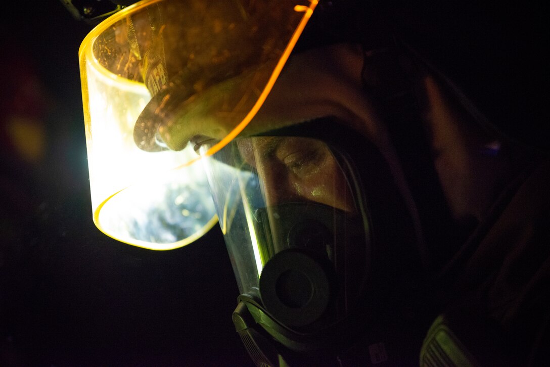 Staff Sgt. Joseph Shelton, 379th Expeditionary Civil Engineer Squadron station chief, checks equipment during a live-fire training exercise August 10, 2021, at Al Udeid Air Base, Qatar.