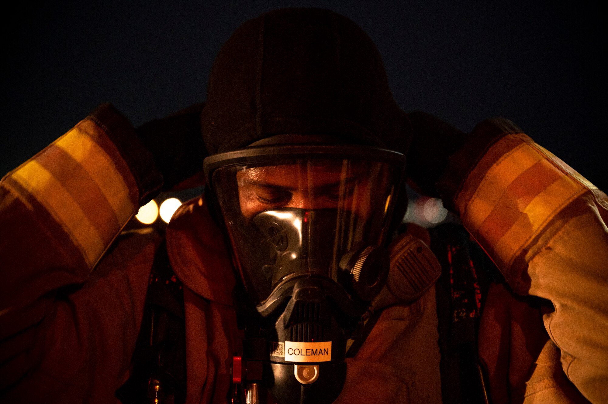 Airman 1st Class Javon Coleman, 379th Expeditionary Civil Engineer Squadron firefighter, dons a self-contained breathing apparatus mask August 10, 2021, at Al Udeid Air Base, Qatar.