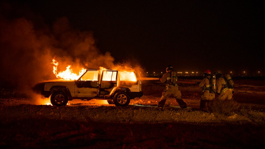 379th Expeditionary Civil Engineer Squadron firefighters put-out a car fire during a training exercise August 10, 2021, at Al Udeid Air Base, Qatar.