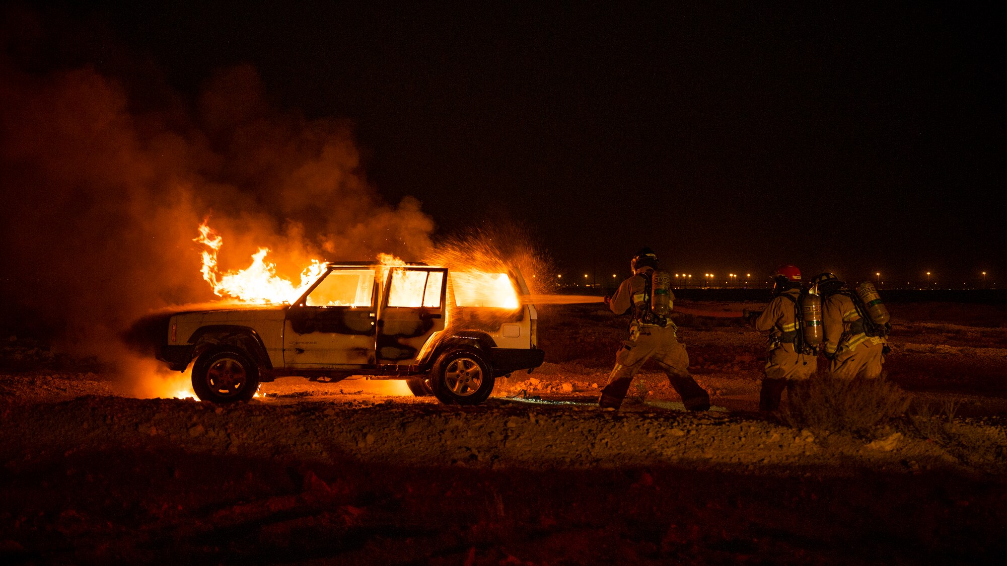 379th Expeditionary Civil Engineer Squadron firefighters put-out a car fire during a training exercise August 10, 2021, at Al Udeid Air Base, Qatar.