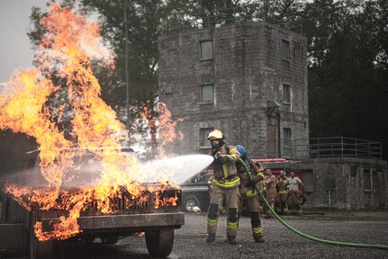 Latvian and Estonian firefighters train on a simulated car fire during Northern Strike 21-2 at the Alpena Combat Readiness Training Center, Michigan, Aug. 6, 2021. Northern Strike is an opportunity to build readiness and interoperability with other units and multinational partners while training in realistic multi-domain environments.