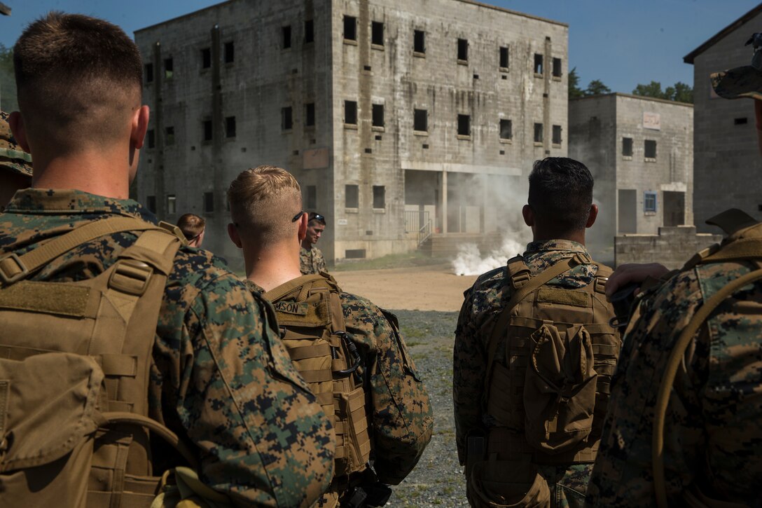 Marines with Alpha Company, Marine Barracks Washington, conduct military operations in urban terrain training at Marine Corps Base Quantico, Va., 11 July, 2021. The Marines learned, practiced, and implemented several different procedures: assaulting toward a building, clearing rooms and stairwells, and different techniques on navigating hallways and tight quarters. They finished the exercise with simulation ammunition and participated in notional squad versus squad engagements to better simulate a live urban environment. (U.S. Marine Corps photo by Lance Cpl. Allen Sanders)
