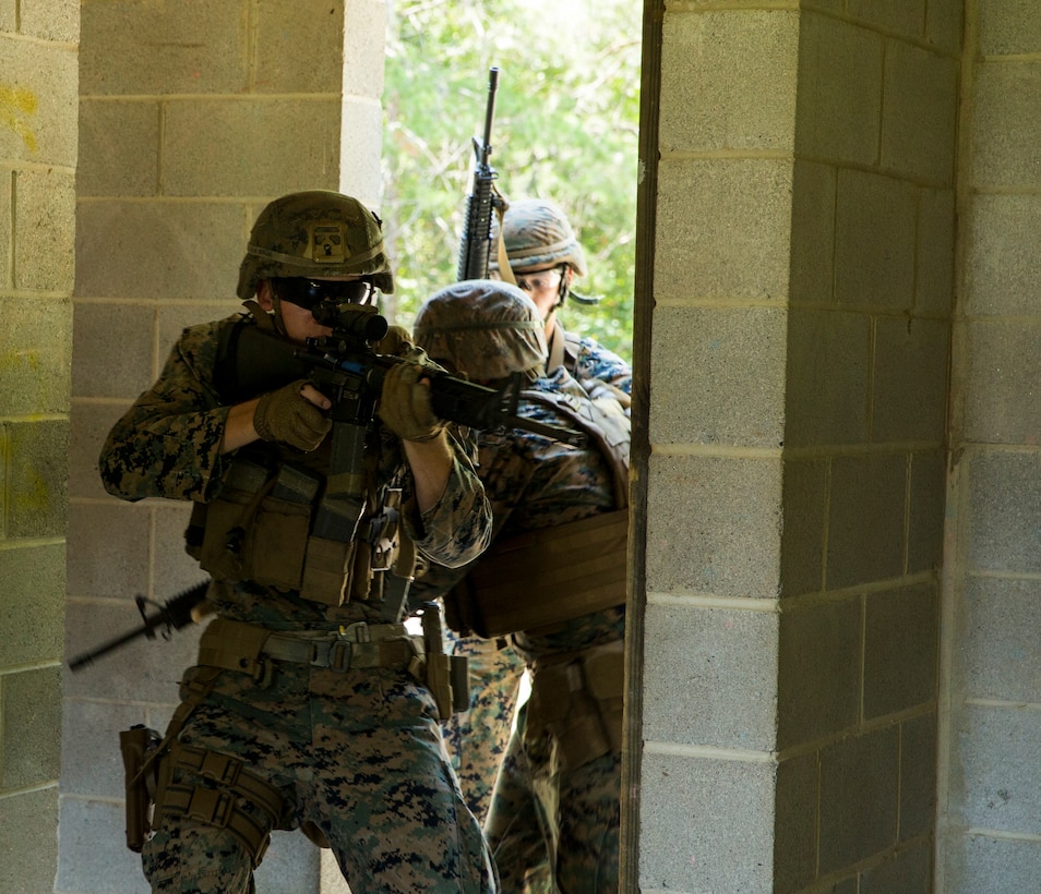 Marines with Alpha Company, Marine Barracks Washington, conduct military operations in urban terrain training at Marine Corps Base Quantico, Va., 11 July, 2021. The Marines learned, practiced, and implemented several different procedures: assaulting toward a building, clearing rooms and stairwells, and different techniques on navigating hallways and tight quarters. They finished the exercise with simulation ammunition and participated in notional squad versus squad engagements to better simulate a live urban environment. (U.S. Marine Corps photo by Lance Cpl. Allen Sanders)