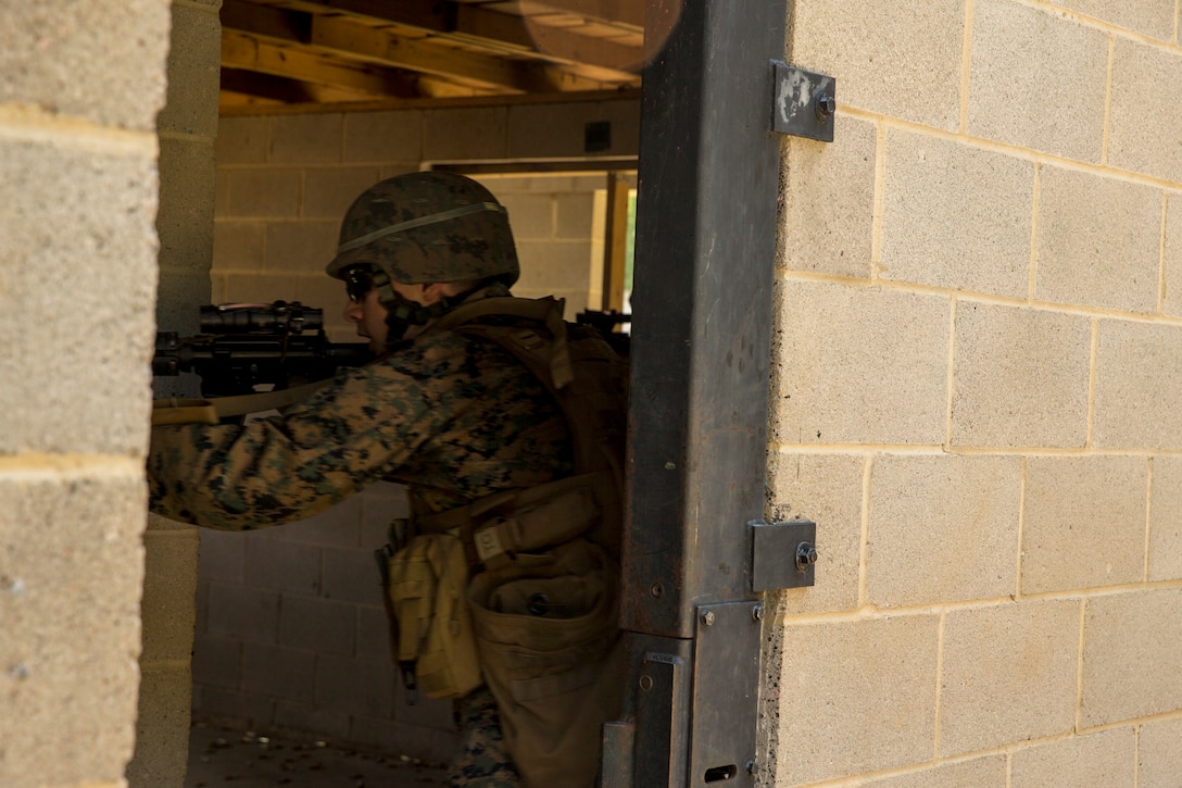 Marines with Alpha Company, Marine Barracks Washington, conduct military operations in urban terrain training at Marine Corps Base Quantico, Va., 11 July, 2021. The Marines learned, practiced, and implemented several different procedures: assaulting toward a building, clearing rooms and stairwells, and different techniques on navigating hallways and tight quarters. They finished the exercise with simulation ammunition and participated in notional squad versus squad engagements to better simulate a live urban environment. (U.S. Marine Corps photo by Lance Cpl. Allen Sanders)